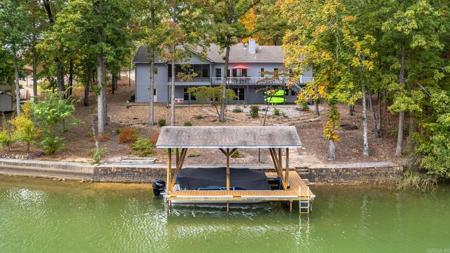 This waterfront oasis is nestled on Hot Springs Villages's largest recreational lake, Balboa. Fabulous lakefront property offering a perfect blend of casual luxury and natural serenity. With 3 bedrooms, 3 full baths, a versatile downstairs entertainment area and a private boat dock, this idyllic haven is a dream come true for those seeking the ultimate waterside lifestyle. Large windows frame the captivating lake views.  It's an entertainer's delight with great flow from kitchen to living room to outside living spaces. Take your choice of dining spaces: formal dining, screened or the open porches. Enjoy days on the water, fishing, and swimming right from your own backyard. The property includes the ADJACENT LOT and many extras convey. Enjoy your pick of hundreds of amenities, social organizations and opportunities to explore nature in the United States' largest gated community. *AGENTS SEE REMARKS