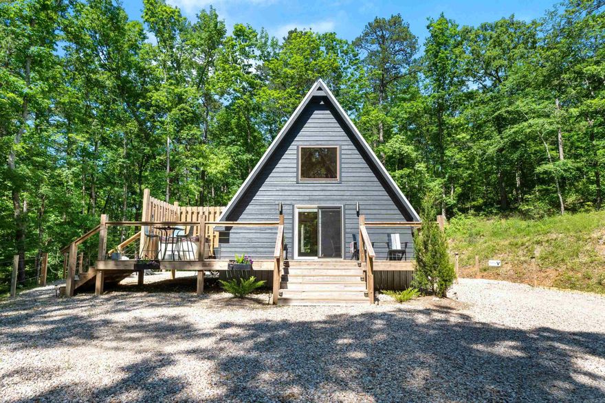 Ouachita Springs Cabins! These adorable cabins are nestled in the woods on approx 19 acres bordering National Forest land and are located just 4 miles from beautiful Lake Ouachita. Currently set up as an active short term rental with proven income. Two 600 sq ft cabins built in 2020 and one 800 sq ft cabin built in 2023. Each custom built cabin features full kitchen, bathroom and loft bedroom with hot tub and grill and are selling fully furnished minus a few personal items. Mulberry creek runs through the front of the property creating a peaceful setting guests love. Plenty of room to expand and add additional cabins or amenities. Gated entrance and perfectly located between Brady Mountain Resort and Crystal Springs and just a short 20 minute drive from downtown Hot Springs. Excellent opportunity for a turnkey investment or private getaway with income potential.