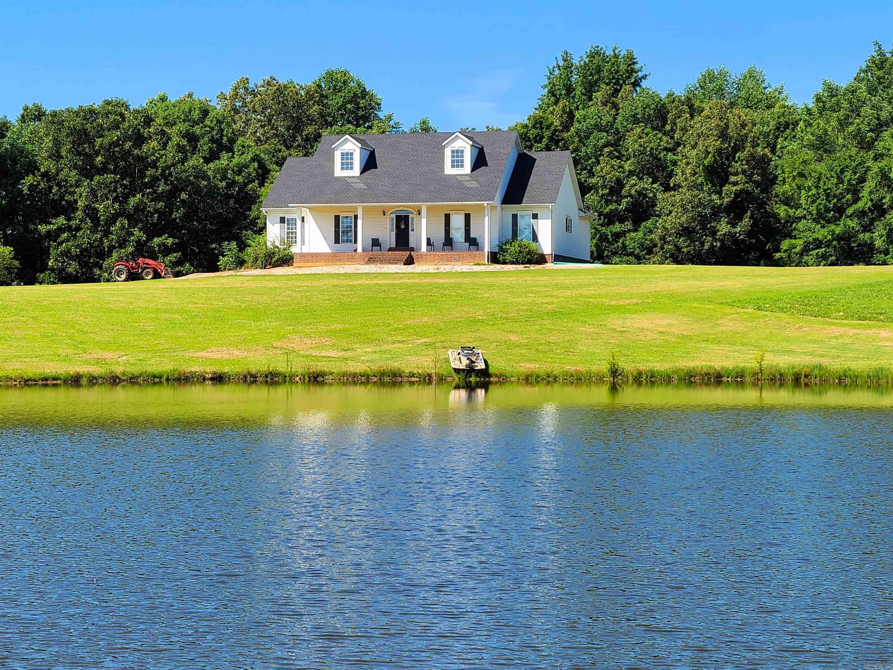 This beautiful 5 BR, 3.5 baths, 4,960 sq. ft home sits on 20 acres of pasture & wooded ground w/a pond! Main level includes a spacious kitchen w/island, a separate breakfast area, a large formal dining area & private laundry room off the double garage entrance. The main level also has a sizable living room w/French doors leading to the back deck, large 1/2 bath off the hall, 2 master BR ea. w/full bath & walk in closets. The larger of the 2 has his/her closets, soaking tub, separate shower, & make-up vanity. The lower level of the home is equivalent to a 2nd home! Downstairs has 3 additional BR, 1 w/a large walk-in closet, a full bath, & a massive family entertainment space. There is an additional room that was previously used as a kitchen w/sink & hook-ups for stove, refrigerator, & washer/dryer, but could be used as an office, game room or 6th BR. The French doors downstairs lead to the covered concrete patio in back. Property includes 24'x30' shop w/12' lean-to on ea. side. This property is equipped to accommodate a large family, an extended family or someone who wants plenty of space & the tranquility of nature. *NEW CH/A unit installed June 6, 2023, NEW shingles/roof May 2024!