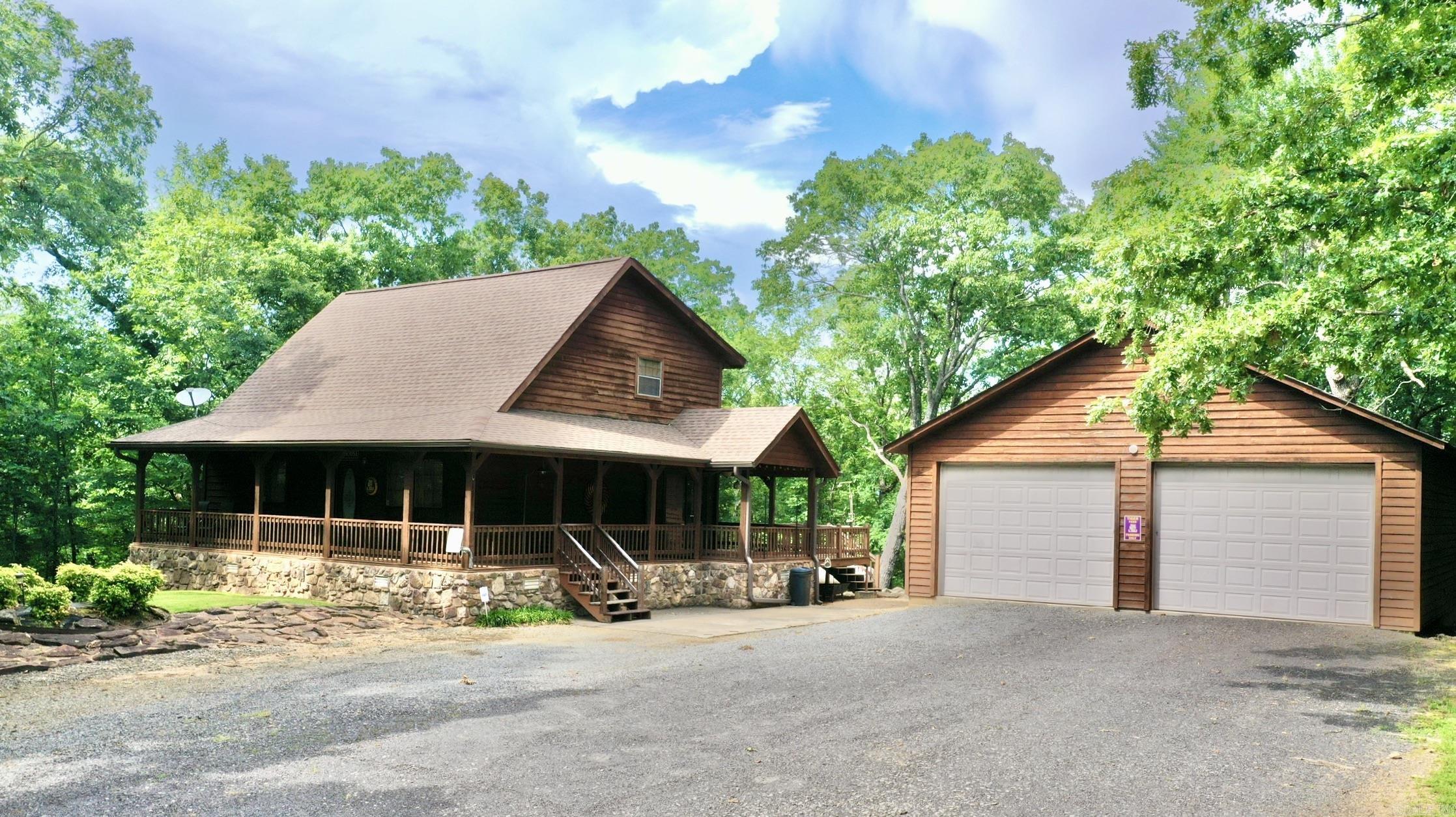 Welcome to the market this 1620 square foot, 3 bed, 2 bath home just minutes from Greers Ferry Lake with easy access to multiple boat launches, including Mill Creek Park. Enjoy the spacious wraparound porch, perfect for outdoor entertaining, and the cozy interior featuring pine hardwood floors, vaulted ceilings, gas log fireplace, and a loft overlooking the living room. A detached 30x36 two-car garage/shop offers plenty of space for your vehicles, boats, or lake toys. Tucked away for privacy yet a short walk to the water, this home is ideal for lake living. Winter lake view from the back deck. Roof is 9 years old, HVAC is original but serviced twice a year, and the water heater is 7 years old.