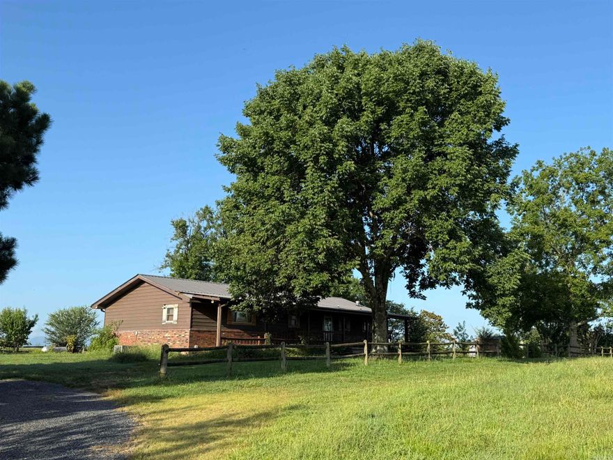 Perched high on a hill, this peaceful 17-acre retreat offers mountain vistas and a rare blend of open space, functional amenities, and scenic beauty. The updated 3-bedroom, 2-bath home, thoughtfully remodeled for full accessibility, features a ramped entrance, wheelchair-friendly bath and shower, and an automatic door leading to a spacious screened-in back porch—ideal for unwinding and soaking in the views!  The kitchen boasts stainless steel appliances and a unique premium Italian wood cook stove that is a work of art!  Recent upgrades include new gutters and downspouts! Outside, discover a well-equipped workshop, a brand-new greenhouse, and a charming barn, all set up for your hobby farm, livestock, or equestrian pursuits. A pond and partial fencing enhance the land’s versatility, while established fruit trees—including apple, cherry, peach, pear, and prune—add natural beauty and seasonal harvests.  Whether you’re seeking a quiet homestead, a small ranch, or simply a place to breathe in the wide-open skies, this property delivers!!