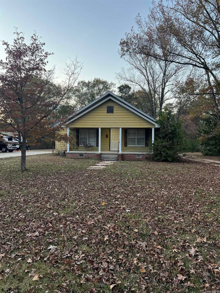 A rare find in the city! Look at this cute 3 bed 2 bath home sitting on over an acre. This homes interior has a great layout with an eat in kitchen and small dining area on the back. The primary bed and bath give you space to retreat. The guest bath is a great neutral and updated space for all your guest. Don't miss the private bedroom upstairs. Outside of the home is a cute front porch and a great covered carport in the back. There are two sheds in the back that could be a great storage with a little TLC. This is a great opportunity to own a great starter home that's been updated and gives you space to make it your own.