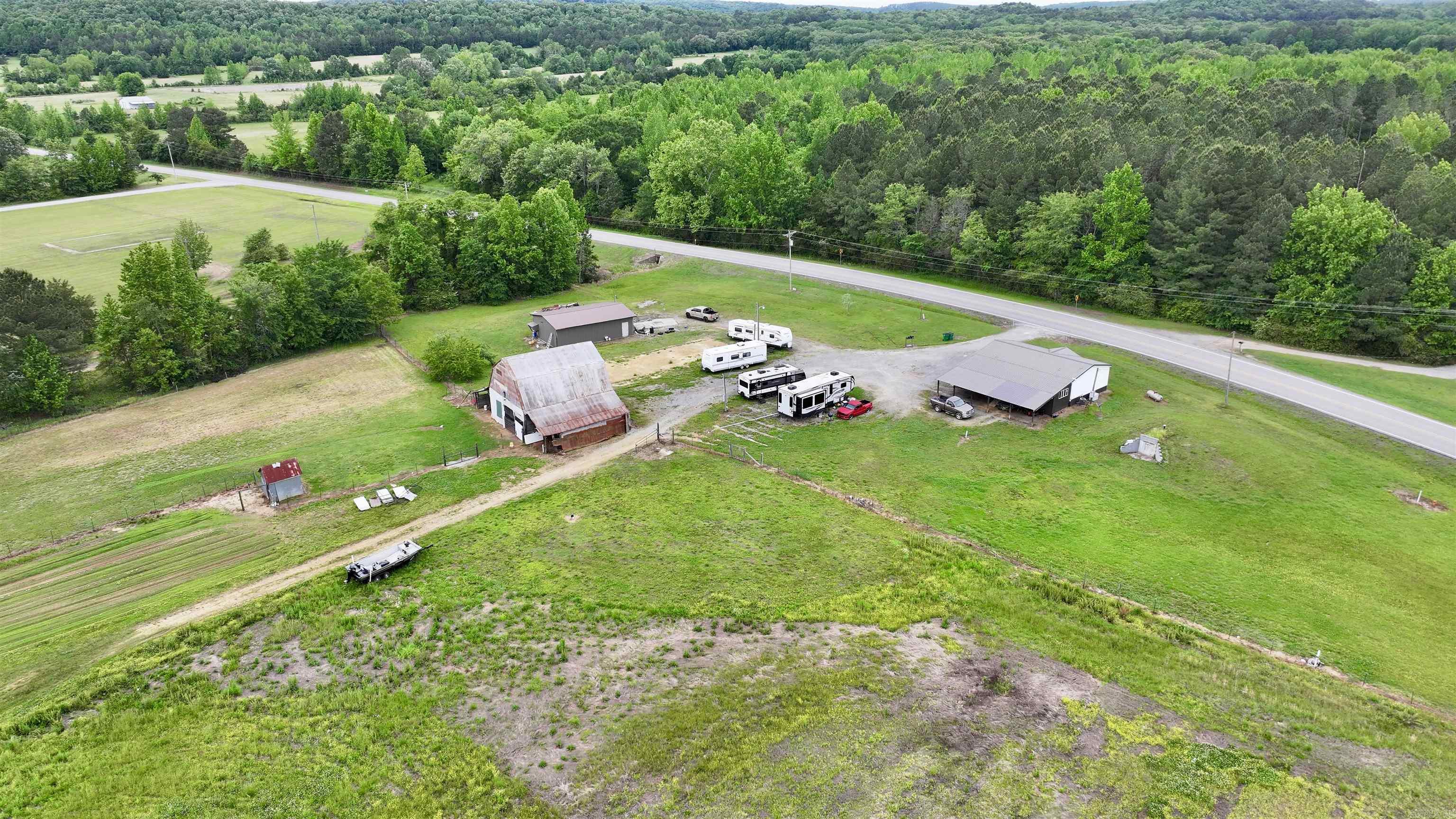Beautiful small farm with huge barn, large 26 x 40 shop, large stocked pond, cross fenced, 3 spetics, storm celler, well maintained double wide with large cover back deck. Great highway frontage. Plenty of room for horses, cows etc, Dont miss this beautiful farm property. So many options or just have some peace and quiet and go fishing.