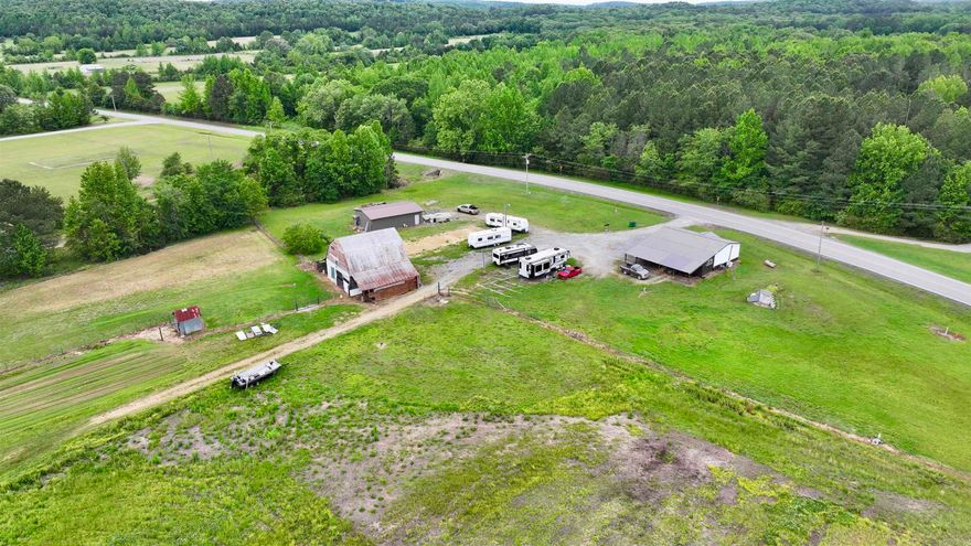 Beautiful small farm with huge barn, large 26 x 40 shop, large stocked pond, cross fenced, 3 spetics, storm celler, well maintained double wide with large cover back deck.  Great highway frontage.  Plenty of room for horses, cows etc,   Dont miss this beautiful farm property.   So many options or just have some peace and quiet and go fishing.