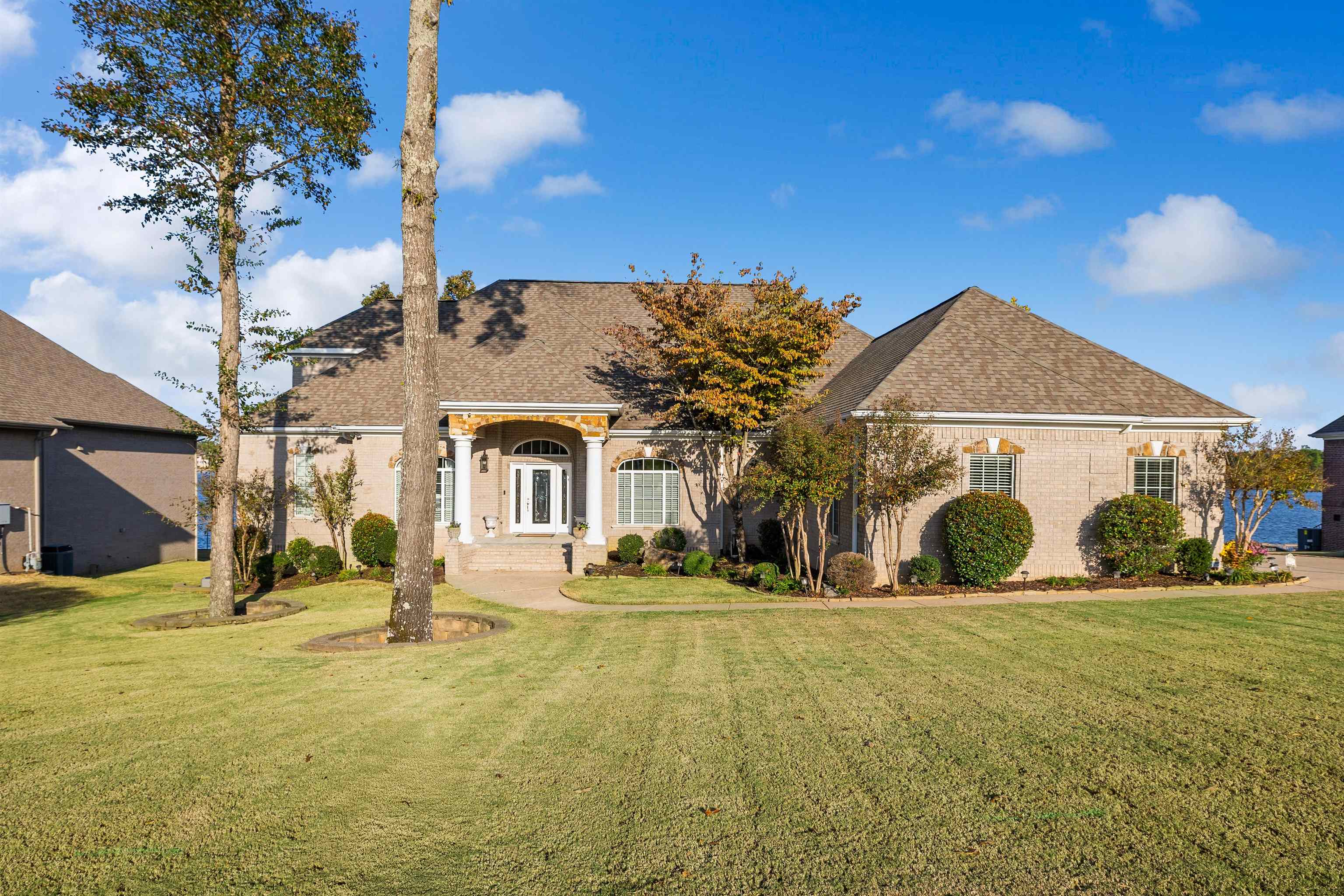 EXTRAORDINARY PANORAMIC WATER VIEWS ON HURRICANE LAKE! This stunning home features lake views from almost every room that are truly remarkable. The spacious chefās kitchen includes a gas range, double ovens, cherry wood cabinets, and opens to a cozy hearth room with a gas fireplace. The primary suite includes a private fireplace, a luxurious bathroom with a double vanity, and a large walk-in closet. A second primary suite on the main level offers additional comfort, while the home also boasts formal living and dining rooms, TWO sunrooms perfect for watching the water wildlife, a theater room, game room, craft room, spacious office with a kitchen, and a workshop area beneath the home. Outside, the large deck is ideal for entertaining, overlooking the flat, fenced backyard with a retaining wall, wrought iron fence, and private boat slip. This is truly a rare find!