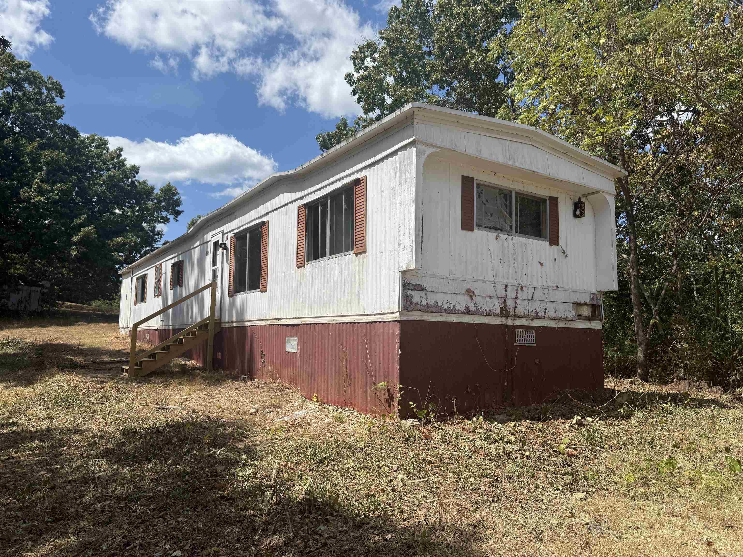 Looking for an affordable project with potential? This 2-bedroom, 2-bath single-wide sits on three lots totaling .78 acres in Country Life Mobile Home Park. The home needs significant work and is being sold as-is, where-is, giving you the freedom to renovate or remove and start fresh. With plenty of space for a shop, garden, or future build, the oversized lots are a rare find in this community. Conveniently located in Midway, you’ll be just minutes from Bull Shoals Lake and all the outdoor recreation the Twin Lakes area has to offer. Whether you’re an investor, handyman, or simply looking for an affordable piece of property in a great location, this is a unique opportunity to create value and make it your own.
