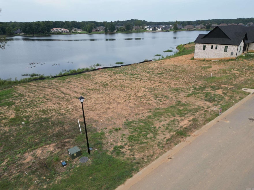 Perfect setting for your custom dream home on this exceptional lakefront lot in prestigious Hurricane Lake Estates! This .34-acre cleared lot for your homesite offers breathtaking unobstructed water views and the ideal backdrop for luxury lakeside living. Whether you're planning a one-story (minimum 2,500 sq. ft.) or two-story (minimum 2,800 sq. ft.) home, this property provides an ideal canvas for lakeside living. Utilities are available, and buyers are encouraged to confirm building requirements with their builder. Community amenities include sparkling community pool splash pads for children new park at the entrance of Phase 1, tennis & pickleball courts lake access for boating and fishing. Year-round community events and activities. Located just 15 minutes from Hurricane Golf & Country Club, shopping centers, and grocery stores. This location combines luxury, convenience, and lifestyle. Don’t miss your chance to own a prime lakefront lot in one of the most desirable neighborhoods in the area. Bring your builder and start planning your forever home today!