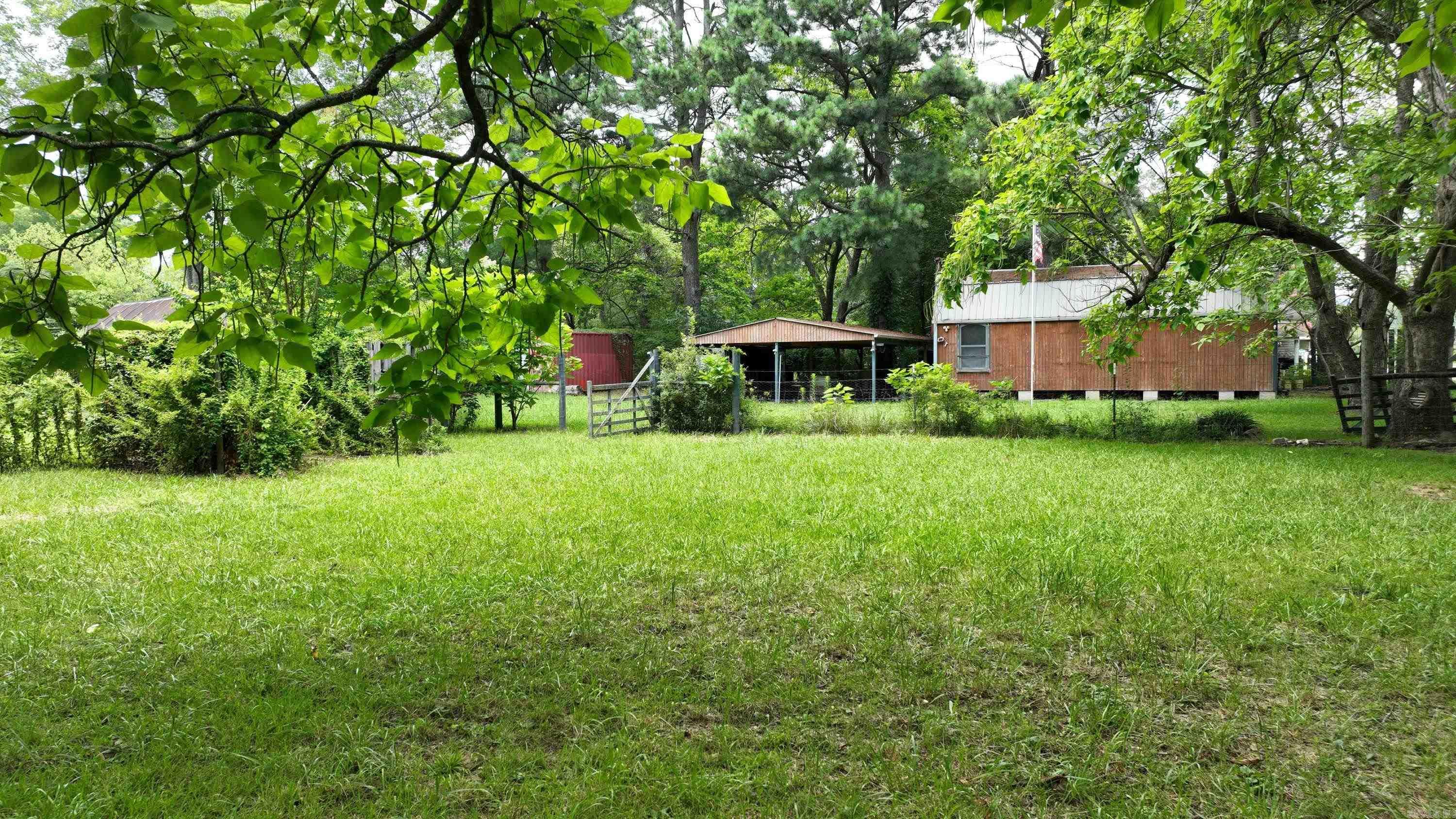 Nearly ½ Acre with Guest House Shell & Outbuildings ā Ready for Your Vision! Looking for a property with room to grow and create? This expansive, nearly ½-acre lot offers a unique opportunity to build your dream setup from the ground up. The land features a partially completed 448 sq. ft. structureāperfect as a starting point for a workshop, studio, or future guest homeāplus power to the building and a previously used artesian well (not currently connected to city water/sewer). You'll also find a large old barn, multiple storage buildings, a carport/shed, garden space, and an animal runāideal for homesteading, hobby farming, or simply enjoying wide-open space. This is a vacant land/lot offering with improvements already in placeāsold as-is and ready for your creativity. Bring your tools, your plans, and your imagination.
