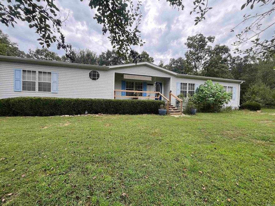 Three bedroom two bath on 4 acres! Stocked pond, garden, several outbuildings, Huge carport! sit on the back deck and just take it all in!