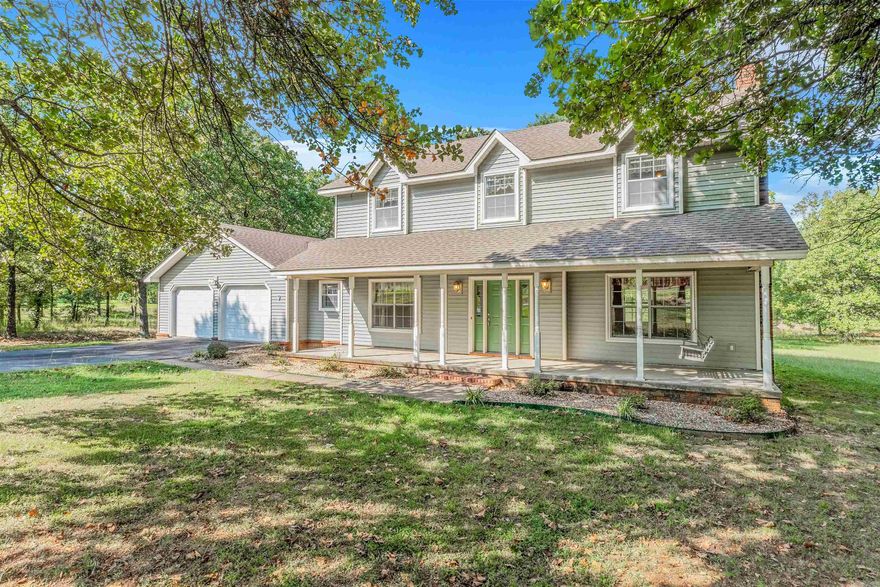 Come swing on the front porch among the beautiful oak trees! This spacious 2,280 sq ft home is perfect for a large family, featuring 4 bedrooms and 2.5 baths. Enjoy two large living areas, a dining room, and a kitchen equipped with granite countertops and stainless steel appliances. Cozy up by the wood-burning stove on chilly evenings! You'll appreciate the convenient laundry room with ample cabinets, and the durable 2X6 walls add extra insulation. The roof was replaced in 2016, and the oversized two-car garage provides plenty of storage. Step outside to a large deck, perfect for entertaining or relaxing. With such generous room sizes, the possibilities are endless. Don’t miss the chance to make this your home. Agents Please see remarks.