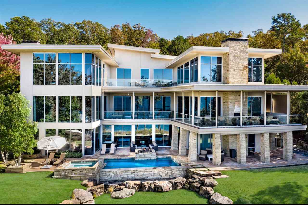 Eden Isle Lakefront Masterpiece! This incredible custom home on Greers Ferry Lake, built in 2012, includes 7 bedrooms (6 are private suites w/ tub & separate shower), 2 spacious living areas, 2 half baths, 2 offices, workout room, 3 kitchens (main level has full chef's kitchen & full prep kitchen) plus full kitchen downstairs, stunning lake views from almost every room, pool & hot tub, wonderful covered outdoor space, 3-car garage (1,015 ft. heat&cool), steel & concrete construction. Features List attached!
