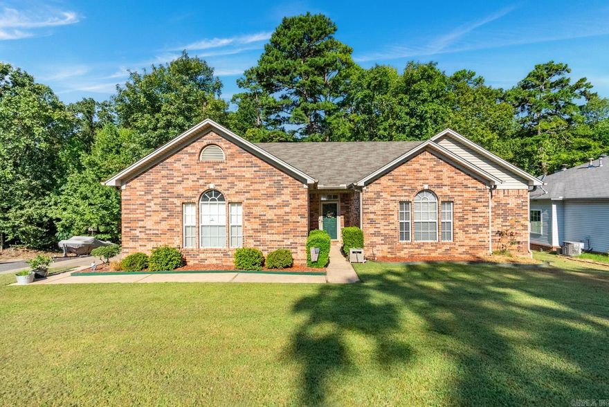 Welcome to Westhampton, a charming all-brick home situated on a spacious lot, backing up to a serene green space in a quiet West Little Rock neighborhood. As you enter, you're welcomed by engineered hardwood floors and a living room with a striking tall peaked ceiling. The semi open-concept living and dining areas offer a cozy dining nook with a view of the backyard. You'll enjoy neutral tones, tasteful touches, and an airy homey feeling throughout. The primary suite boasts a generous bathroom with double vanities and double closets. Two additional guest bedrooms share a stylish guest bath. Step outside to a large backyard, perfect for entertaining, with the added benefit of green space for privacy. This home offers so much to love and is sure to go quickly. Don’t miss out on this charming home and incredible opportunity!