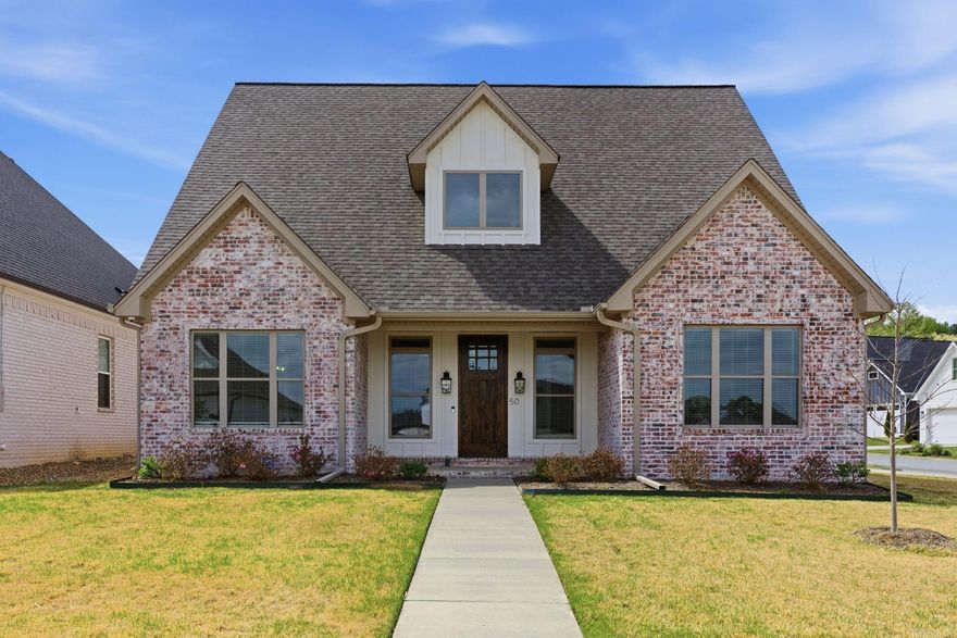 Incredible value at under $187/sf and built in 2023!! Situated on a spacious corner lot, this 2023-built home offers modern design with a timeless aesthetic. The side-load two-car garage enhances curb appeal, while the open-concept layout is ideal for entertaining. A dedicated dining room opens to a bright kitchen featuring a large island with bar seating, marble countertops, pendant lighting, stainless appliances, gas cooktop, and walk-in pantry. The kitchen flows seamlessly into the inviting living area with a brick fireplace and gas logs. The main-level primary suite offers dual walk-in closets, double vanities, soaking tub, walk-in shower, and convenient access to the laundry room. Upstairs includes two additional bedrooms plus a large bonus room—perfect for a playroom, office, or media space. Enjoy outdoor living on the covered patio overlooking the fully fenced, level backyard. Neighborhood park and pool coming soon. Conveniently located near shopping, dining, and top-rated schools.