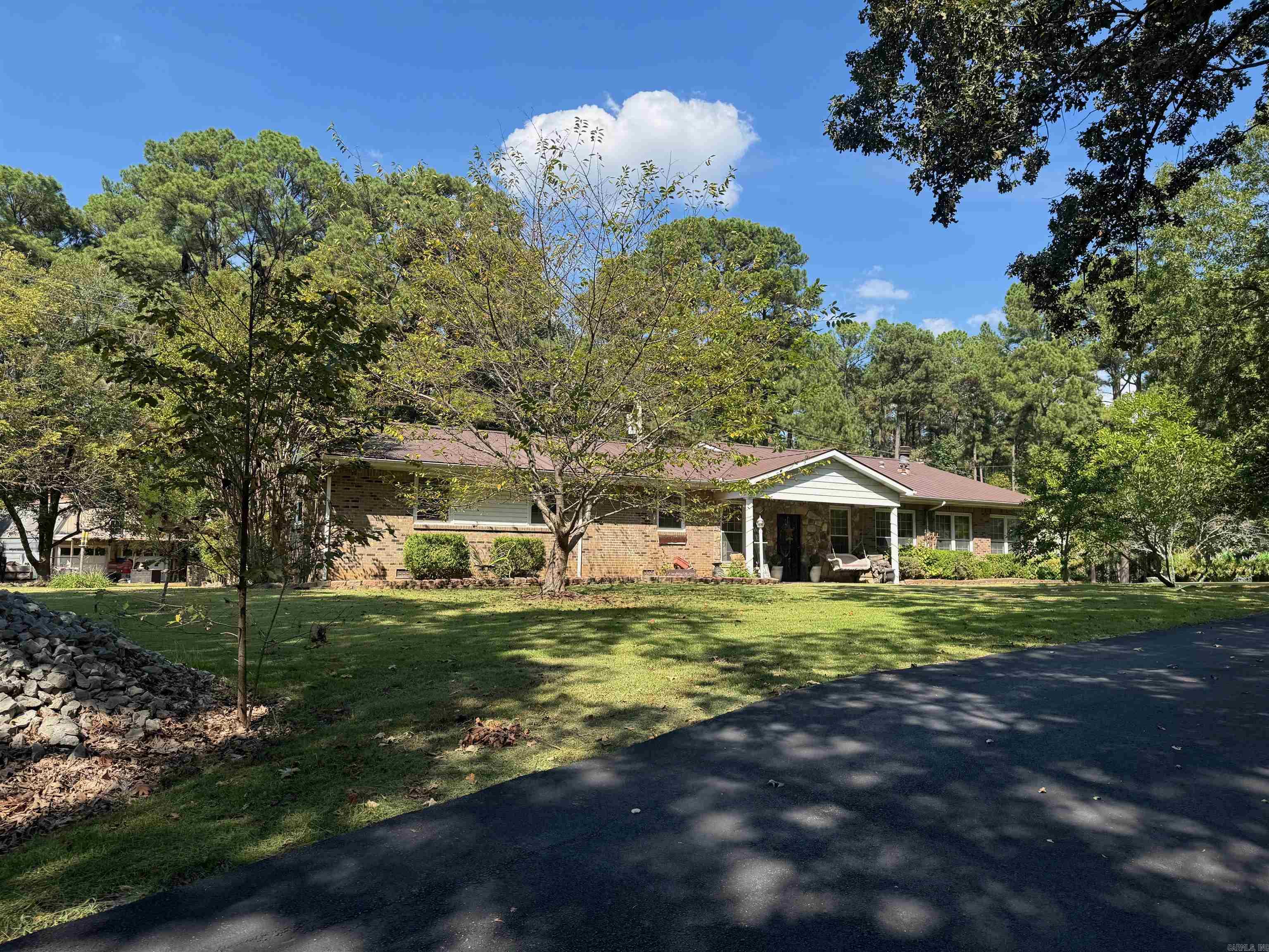 Looking for more space outside of town where you can grow a garden and tinker in your own shop? This is it! This property has pecan, apple, & pear trees. Plus blueberries, grapes, and muscandine vines on site! There is a workshop and another outbuilding on the 2 acre lot as well. Inside the home you will find 4 bedrooms and 2 bathrooms. There are 2 wings of the home which could serve for an in-laws suite if someone were so inclined. One side has 3 bedrooms, a bath and a kitchenette. The other wing has a huge den with a fireplace and kitchen with a breakfast bar that seats 8! There is also a big bedroom with a bath across the hall that has a jet tub and a shower. One great amenity is access to a storm shelter from inside the kitchen. You will also loved the covered decks overlooking the fenced section of the backyard. It is so peaceful! This home does have a wood furnace that can be used if you so choose to offset the cost of your utilities.