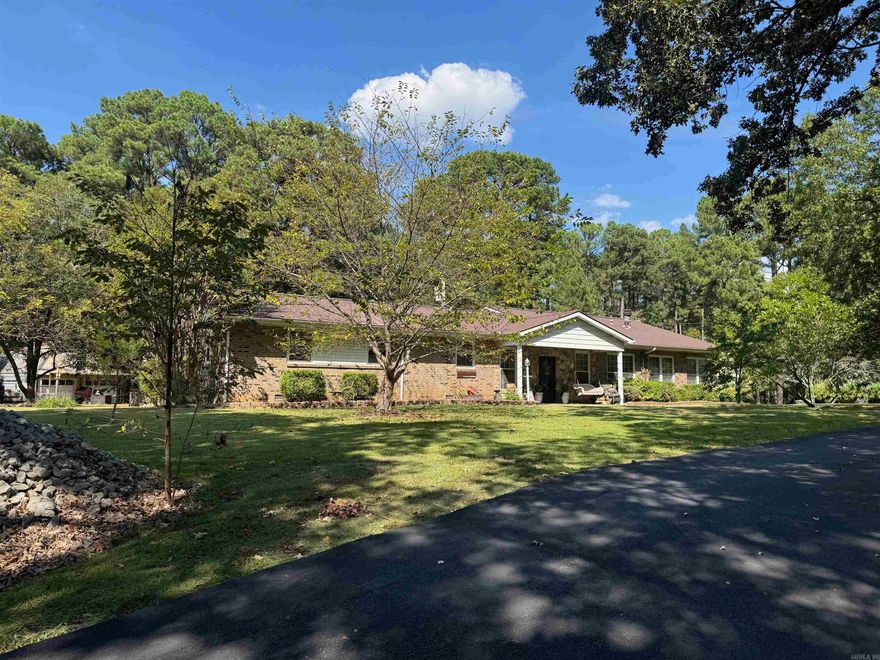 Looking for more space outside of town where you can grow a garden and tinker in your own shop? This is it! This property has pecan, apple, & pear trees. Plus blueberries, grapes, and muscandine vines on site! There is a workshop and another outbuilding on the 2 acre lot as well.   Inside the home you will find 4 bedrooms and 2 bathrooms. There are 2 wings of the home which could serve for an in-laws suite if someone were so inclined. One side has 3 bedrooms, a bath and a kitchenette. The other wing has a huge den with a fireplace and kitchen with a breakfast bar that seats 8! There is also a big bedroom with a bath across the hall that has a jet tub and a shower. One great amenity is access to a storm shelter from inside the kitchen.   You will also loved the covered decks overlooking the fenced section of the backyard. It is so peaceful!  This home does have a wood furnace that can be used if you so choose to offset the cost of your utilities.