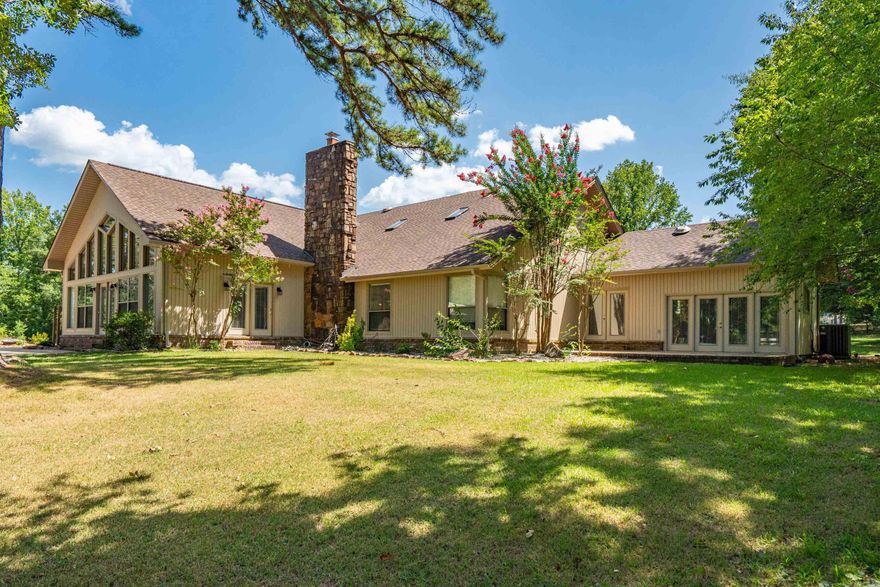 This beautifully updated Lake Hamilton home is set on 150 feet of prime lake frontage with a seawall, 75-foot boardwalk, and private boat dock. Over the last year, major improvements include a new roof, siding, gutters, windows, and fresh paint, making this home move-in ready and worry-free. Enjoy year-round comfort with a top-tier air purification system (REME HALO), commercial-grade Ultra Aire whole-house dehumidifier, and additional filtration systems.  Step inside to a spacious great room with 20’ soaring wood ceilings, rich hardwood floors, and a stone fireplace with Buck Stove insert. The large primary suite includes a sitting area, lake views, and private access to a concrete patio overlooking the water. The home features two remodeled tile bathrooms, a formal dining room, and a well-appointed kitchen with breakfast bar, wet bar, and eat-in area. Entertain with ease in the 20x30 game room.  Upstairs, you’ll find two generously sized bedrooms connected by a Jack-and-Jill bath, plus a floored walk-in attic for additional storage. Other highlights include a new 14x24 lakeside pavilion, a 12x24 side deck, laundry room, and a private office just off the kitchen. Agent is owner.