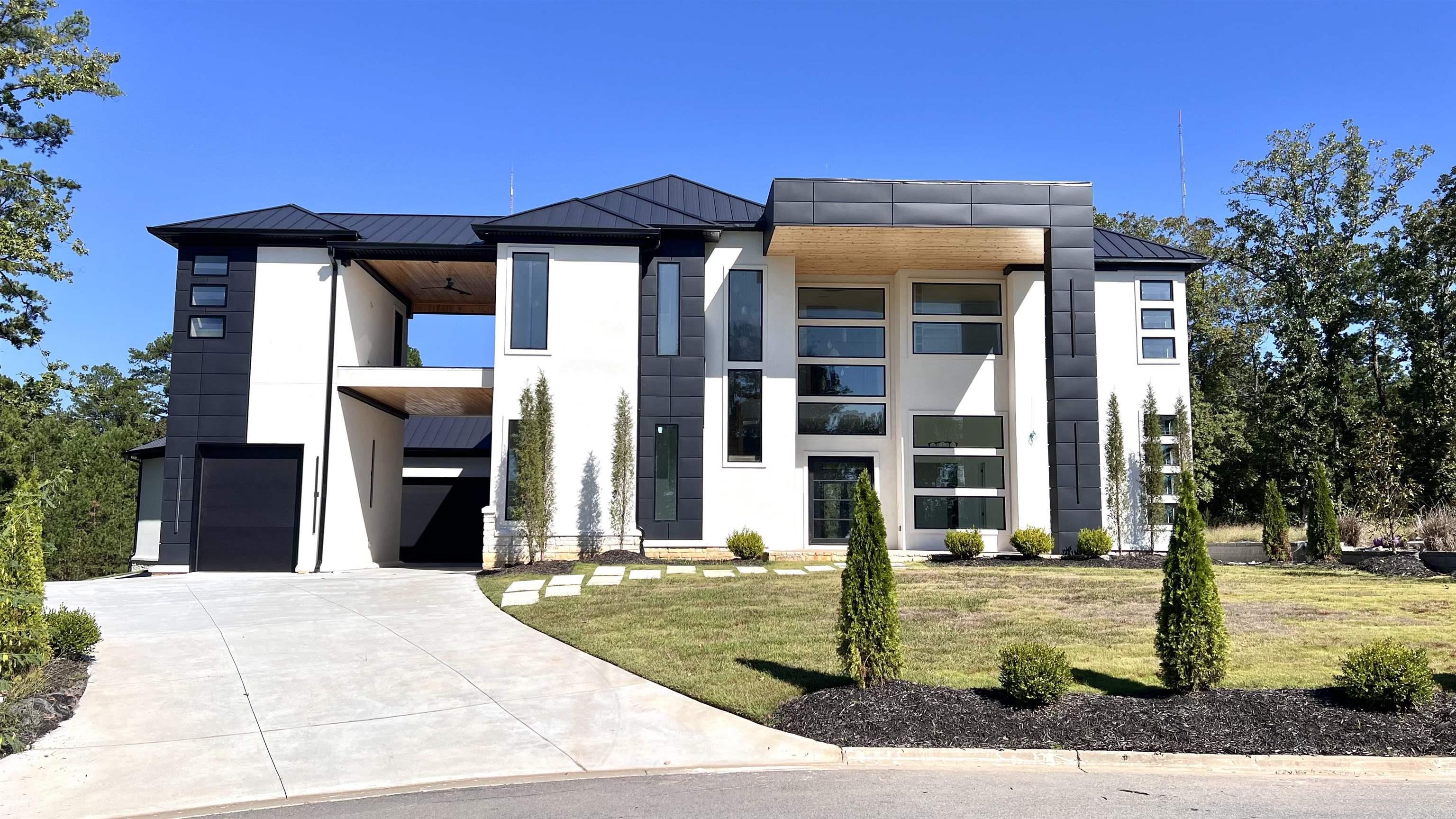 This exceptional West Little Rock residence, showcases floor-to-ceiling windows, soaring ceilings, and an open-concept design filled with natural light. Elegant details include luxury lighting, exotic stone accents, a handcrafted chandelier, and distinctive flooring. Designed for entertaining, the home offers dual kitchens and pantries, sleek appliances, high-end finishes, and a dramatic waterfall island. Additional features include a private fitness room with wet bar, a custom theater, and expansive balconies with serene views. With multi-car garages, a courtyard entry, and bespoke finishes throughout, this property is a rare opportunity in one of West Little Rock’s most sought-after locations.