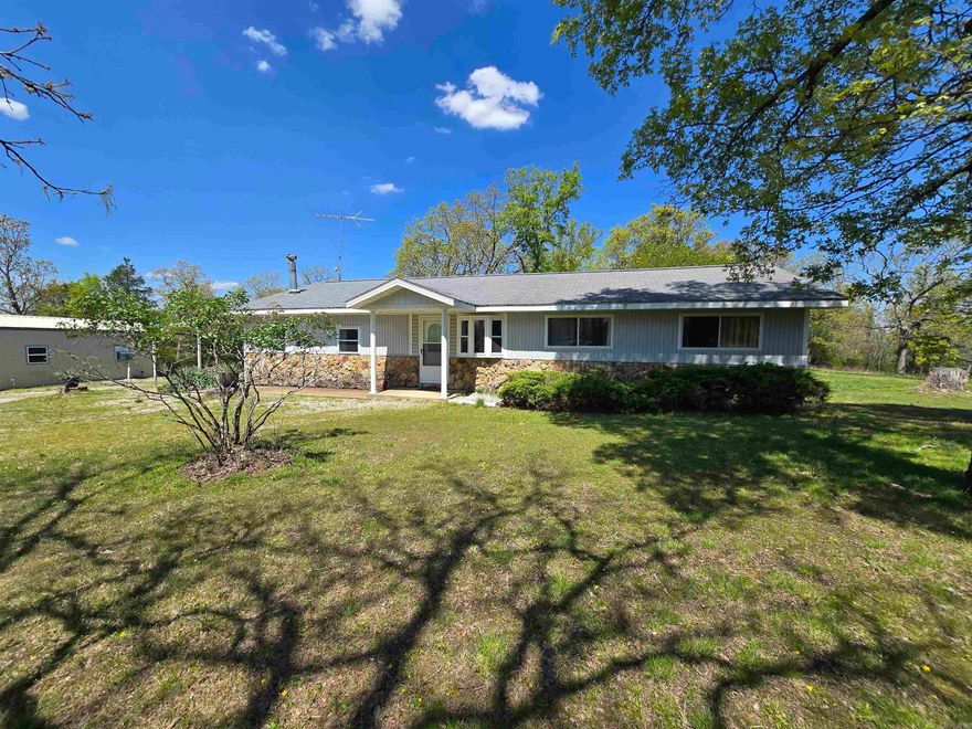 Wildlife galore - hunter's paradise with a large deer stand. Less than 15 miles to Mountain Home amenities. Looking for privacy and still be close to the lake. Lake access is 10 minutes away!  Main home is a 3/2 ranch, 1617 sq ft, wood stove in den, full house generator, water filtration system, water softener, 500 gallon propane tank, entire property fenced with two strand barbed wire, 30 x 30 shop building insulated with electric, propane heat, window unit cooled, and concrete floor. Next, high-speed internet is available! 35.22 acres m/l $425,000.