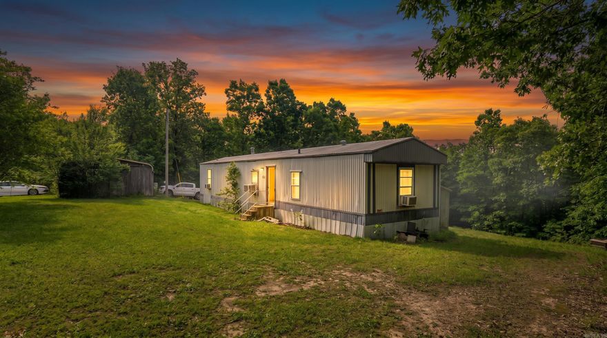 Cozy Country Home in the Arkansas Ozarks   Enjoy peaceful country living on this beautiful 5-acre property located less than 3 miles from Mammoth Spring State Park and Spring River. This 2-bedroom, 2-bath home offers a quiet setting with plenty of room to relax and enjoy the outdoors. The property features a spacious workshop that is perfect for projects, hobbies, or extra storage, along with a chicken coop for those interested in hobby farming or fresh eggs. A storage shed and 1-car garage provide additional convenience and functionality. With five usable acres, there is plenty of space for gardening, recreation, or simply enjoying the privacy of rural living. Outdoor enthusiasts will love the close proximity to Spring River and Mammoth Spring State Park, known for fishing, floating, kayaking, and hiking. Whether you are looking for a full-time home, weekend retreat, or small hobby farm, this property offers a great combination of comfort, convenience, and country charm.