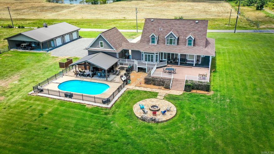 COUNTRY LIVING AT ITS FINEST. Check out this amazing home with hardie board siding, a luxurious in-ground saltwater pool, multiple outdoor entertaining areas, wrap-around porch, on a level 2+ acre yard partially fenced. The detached 3-bay 40x70 shop (40x50 heated and cooled) offers endless possibilities for hobbies, storing lake toys, classic cars, fun projects, etc. Above the 2-bay garage, there's a 300 SF heated and cooled bonus room, perfect for a man cave, home gym, or office. Central vac system in garage. Step outside to your own private oasis and lounge by the sparkling pool on sunny days or unwind/hang out with friends in the shade of the covered patio while catching the game on TV. The pool area is fenced for safety, where you'll find a cooking area, storage area, entertaining area, and half bath. Outside the fenced-in pool area, you have an expansive deck for entertaining, and you can step down to the fire pit for those nights you just want to sit by a fire. Vista views of Sugarloaf Mountain. See all the holiday fireworks from your own yard. Two miles to Shiloh Marina. Half a mile to city park. Corner lot. Beautiful landscaping.