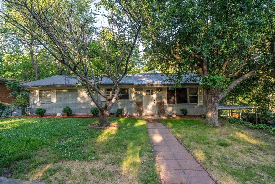 This beautifully remodeled 3-bedroom, 2-bathroom home in Hot Springs offers 2,726 sq ft of living space on a 0.36-acre lot. The main level features 2 bedrooms and a luxurious walk-in shower. The finished basement includes a spacious bedroom, full bath, mini kitchen, and ample closet space—perfect for multi-generational living or entertainment. Recent updates in 2022 include a new metal roof, modern finishes, and an above-ground pool. Additional amenities include a carport, patio, and outdoor storage. Located in the Whitfield subdivision with creek views and no HOA fees.
