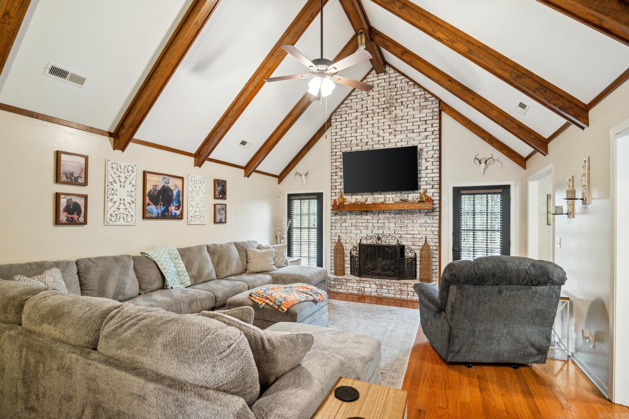 Peaceful Retreat Near Lake Poinsett | 3 Bed | 3 Bath | Over 2,000 SF | 2.17+/- acres. Welcome to your serene woodland escape on 2.17 +/- acres, just a half-mile from Poinsett State Park! Nestled on a beautifully wooded lot with privacy and nature all around. This 3-bedroom, 3-bath home offers over 2,000 square feet of comfort, character, and room to grow. Inside, you'll fall in love with the warm hardwood floors, natural light from two bay windows, and a cozy living room with vaulted ceilings, exposed beams, and a stunning whitewashed brick fireplace. The kitchen is full of charm and function with white cabinetry, dark countertops, natural gas cooktop, breakfast bar, beautiful brick flooring, and a gorgeous tongue-and-groove wood ceiling that adds flair. A flexible (main floor) bonus room with built-in shelves can serve as an office or even a fourth bedroom. Storage is abundant with multiple closets, a large floored attic, and an additional storage closet in the two-car garage. Step outside onto the expansive back deck, perfect for entertaining or simply relaxing while surrounded by peaceful woods. There's space for grilling, a fire pit, and multiple seating areas.