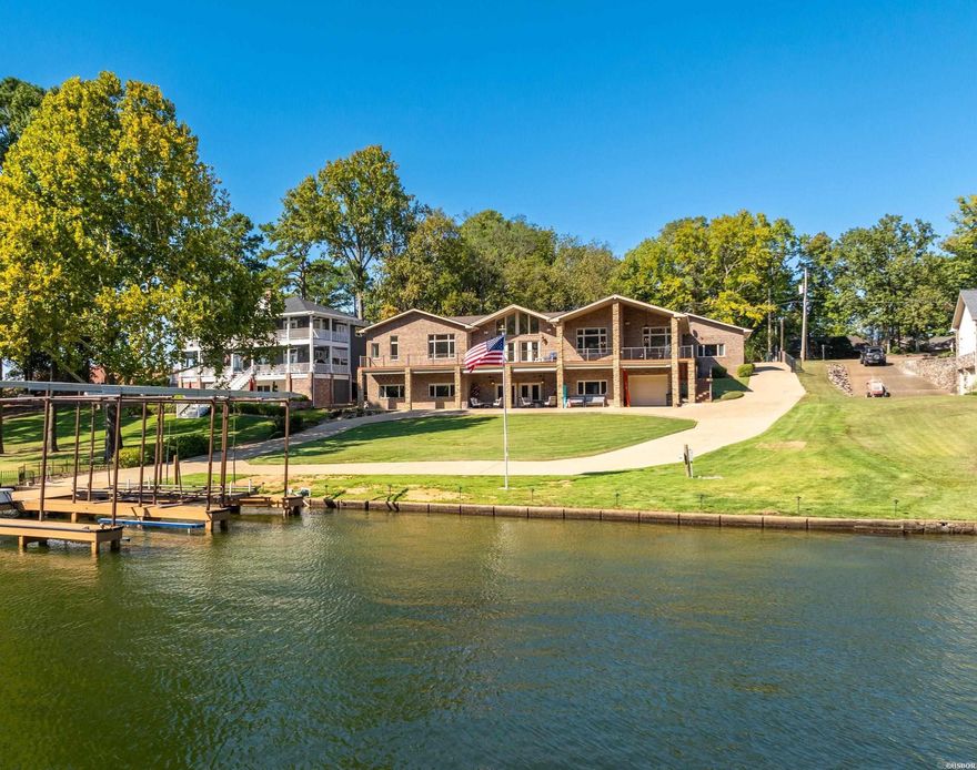 Beautifully remodeled 5 bed, 3.5 bath home on Lake Hamilton with a prestigious Hwy 7 South address, nestled just off Long Island. The home boasts a new roof, new gutters with leaf guards and updated interiors, including a fully renovated kitchen with custom cabinets, countertops, and new appliances. The spacious primary suite features a luxurious bath, while vaulted ceilings and a gas fireplace enhance the open living spaces. Additional highlights include a 3-car garage, whole-home automation, separate lower level garage with workshop and ample storage. The lower level offers a separate kitchen and living area, perfect for entertaining, and opens to a stunning patio overlooking the lake. Outside, enjoy a two-stall boat dock with a jet ski slip and the peace of mind of a Kohler home generator. Located in Lakeside School District, this home offers spectacular lake views from both the upper deck and lower patio in one of the most sought-after locations on Lake Hamilton.