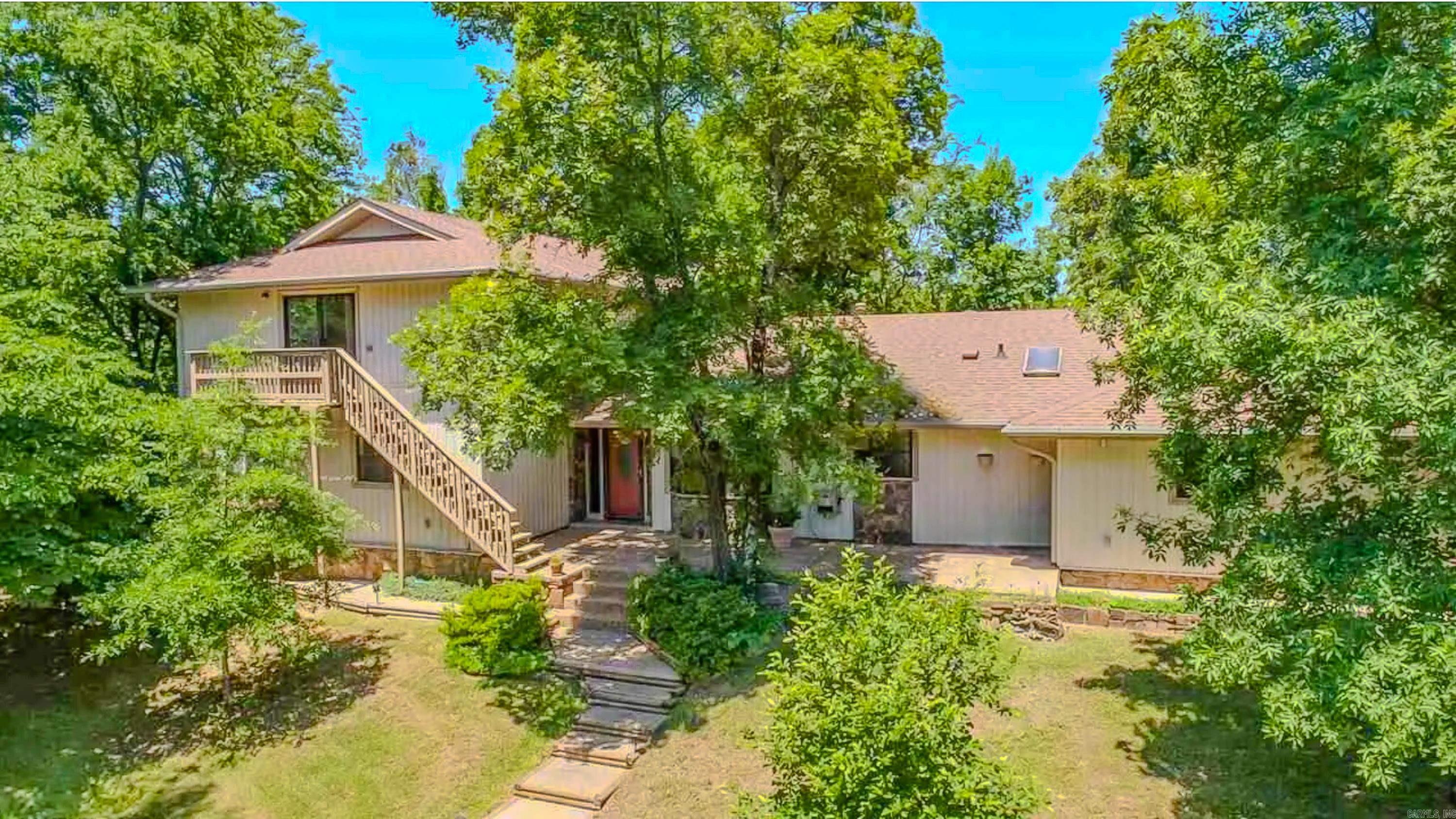 Distinctly crafted unique home off Hwy 5 offers peaceful and private living and lots of updates and conveniences. Easy access to !-57 for commutes to LRAFB or metro area. Incredible views of the valleys and set off road for privacy. Chef's kitchen with lots of natural lights , granite counter tops, tile back splash, butcher block center island and upgraded appliances. Home has 2 car side load garage, detached garage and gardeners shed. Wonderful entertaining space with in ground salt water pool large deck covered area. New roof in 2024 and pool liner 2025.