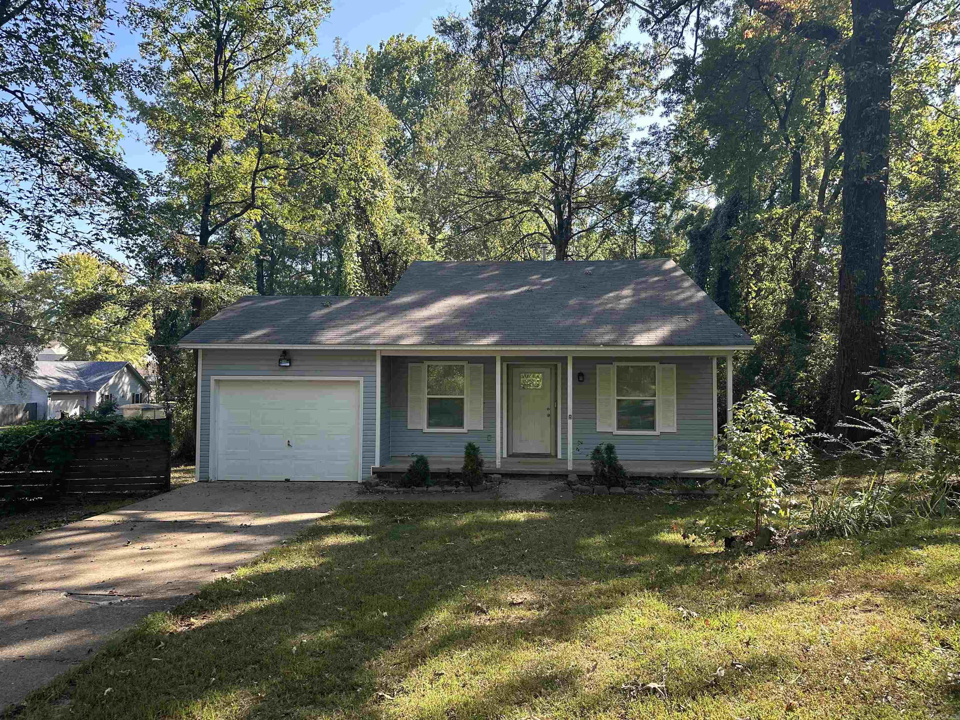 Nestled on over an acre of land, with a portion fully fenced for privacy, this charming, fully updated home offers modern comfort and style in just over 1,000 sq. ft. Perfectly move-in ready, the home features brand-new stainless steel appliances, including a sleek oven, refrigerator, and dishwasher, ideal for any home chef. The interior is beautifully enhanced with luxurious vinyl plank (LVP) flooring throughout, combining durability and contemporary design. Freshly installed windows, new baseboards, and blinds bring in ample natural light, creating a bright and welcoming ambiance. Several of the interior and exterior doors have been replaced for added security and style, and a new garage door opener adds convenience. Topped off with fresh paint inside and out, this beautifully renovated home is a true turnkey gem, offering peace, privacy, and modern living. Agents see remarks