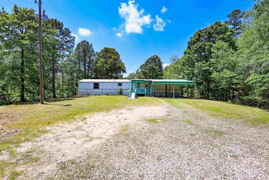 Nestled on 4.27 wooded acres in the sought-after Fountain Lake School District, this 3-bedroom, 2-bath single-wide mobile home offers privacy and potential. The quiet, convenient location makes it ideal for those looking to enjoy a peaceful setting without being far from town. Property features well water and includes a cute playhouse or storage shed. Whether you’re searching for an investment, rental, or a place to make your own, this property is full of opportunity.