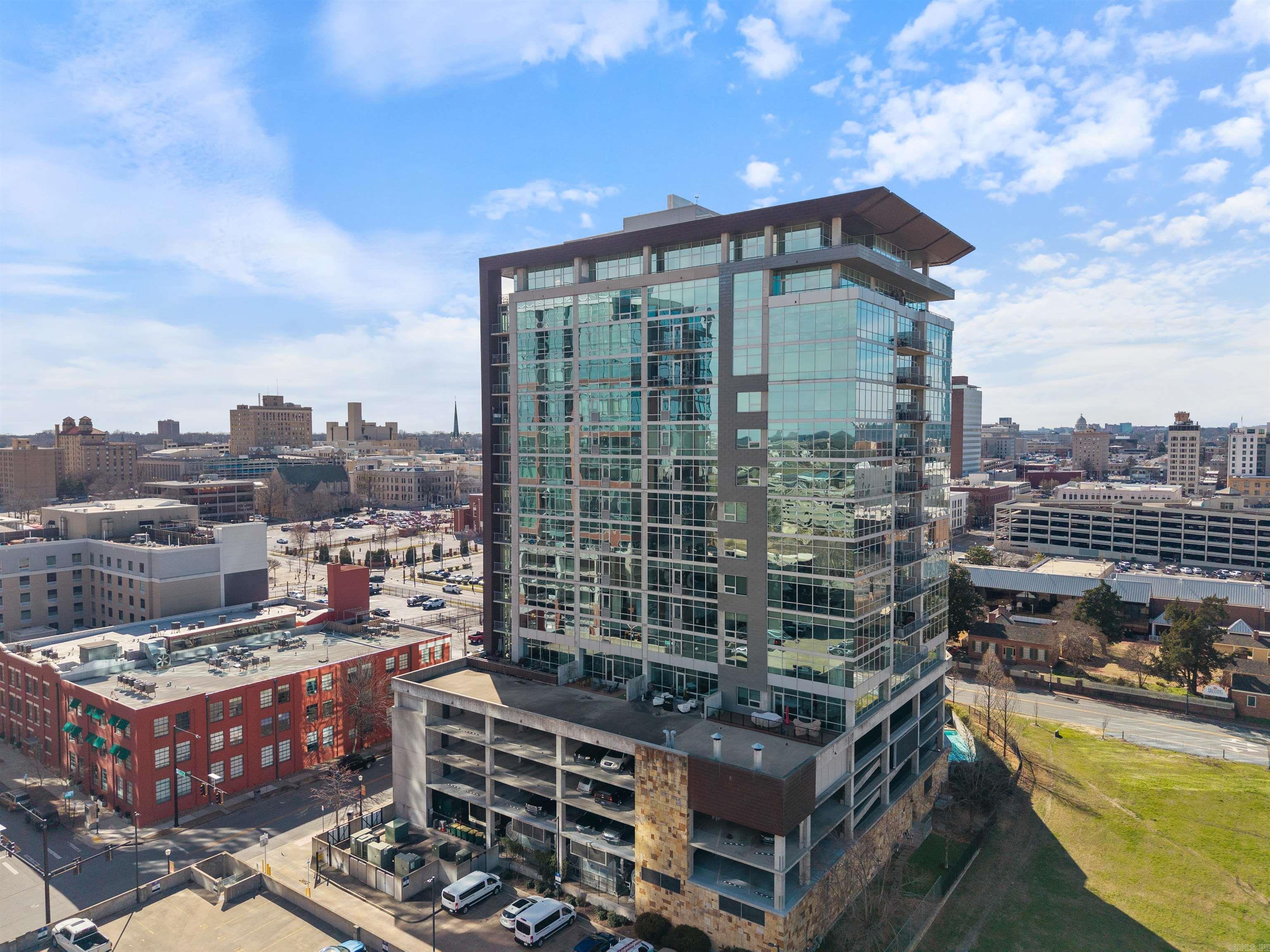 Experience sophisticated urban living in one of Capital Cityās most prestigious high-rises. Designed by architect Tom Fennel, AIA, and built by Dave Grundfest Company, this exquisite residence offers elegance, craftsmanship, & convenience. Enjoy breathtaking panoramic views of the Arkansas River from the moment you enter. The interior features site-finished oak herringbone flooring, custom millwork, and meticulous detailing throughout. The main level boasts an expansive great room, formal dining, private study, and guest suiteāall capturing stunning river & skyline views. The kitchen is a chefās dream with top-tier appliances, custom cabinetry, and an informal dining area. A grand staircase or private elevator leads to the upper level, home to an opulent ownerās suite with a study, fireplace, spa inspired baths, and a custom walk-in closet. Two additional bedroom suites and a laundry room complete this level. Additional highlights include an incredible covered patio, an advanced AV system, and four parking spaces. Residents enjoy condo amenities: pool, spa, fitness center, dog-walking area, gated parking, concierge services, and direct access to Copper Grill with delivery service.