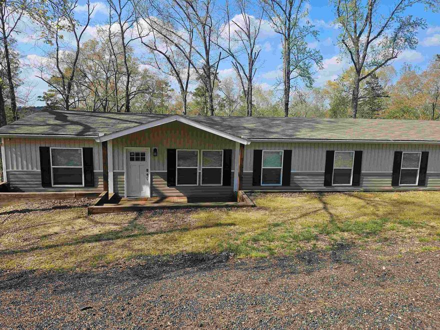 Double wide mobile home offering 5 bedrooms and 3 bathrooms on approximately 1.10 acres. Currently operating as a short-term rental. Located minutes from Lake Greeson with access to nearby walking and ATV trails, and approximately 10+/- miles from Albert Pike Recreation Area in the Ouachita National Forest. Great opportunity for personal use or investment. Agents see remarks.