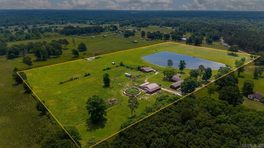 Absolutely stunning 23.4-acre property just minutes from town! This private estate features a spacious 4-bedroom, 3-bath home with incredible views throughout. The main home offers 8' ceilings in most areas, with a gorgeous den boasting 12' tongue-and-groove ceilings. A large, scenic stocked pond adds to the property’s beauty!  Horse lovers will appreciate the impressive barn with 13 stalls, a wash rack, and a turnout pen. In addition, the property includes an approximately 1,100 sq ft studio home complete with a full kitchen, bedroom, and bath, plus an attached foaling barn—ideal for caring for and monitoring new foals.  Roofs on all three buildings are approximately 3 years old! This rare find combines convenience, privacy, and outstanding equestrian facilities in one exceptional property.  Large Storm Shelter!  Agents see remarks.