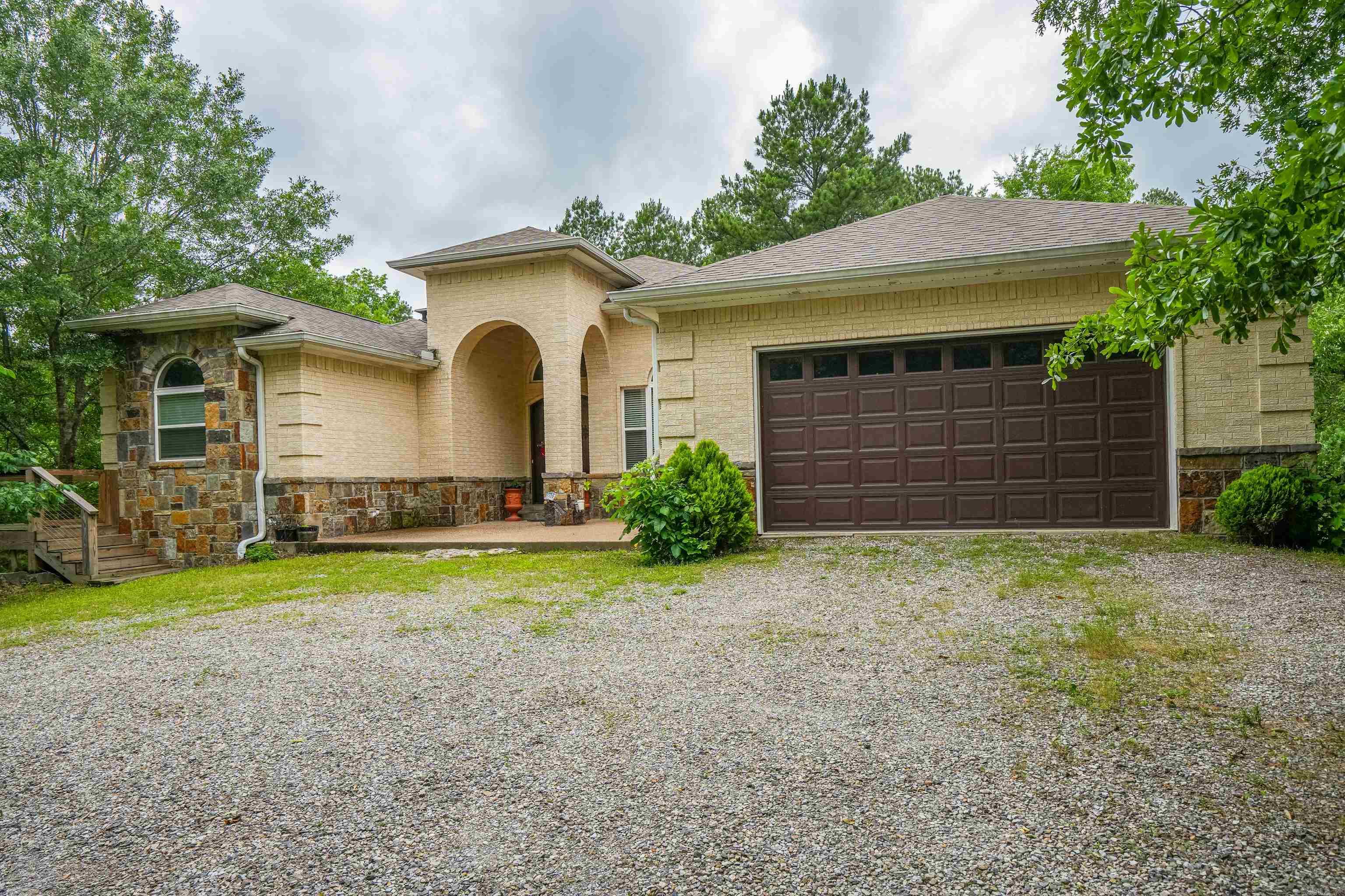 Discover this beautiful private home nestled on 6 wooded acres, just minutes from Lake Hamilton Schools. With 5 bedrooms, 4bathrooms, and multiple living spaces, this home offers room for everyone-plus the perfect layout for entertaining. The main level features a spacious kitchen with breakfast area and an open dining room, and a large main suite with private bath. Two additional bedrooms and bathrooms are also on the main floor, along with a versatile room that can serve as an office or extra bedroom. Downstairs you will find a generous entertaining space complete with bar, woodburning fireplace, plus another bedroom and full bath-ideal for guests or multigenerational living. Step outside to a peaceful deck surrounded by trees and nature, your own private retreat!