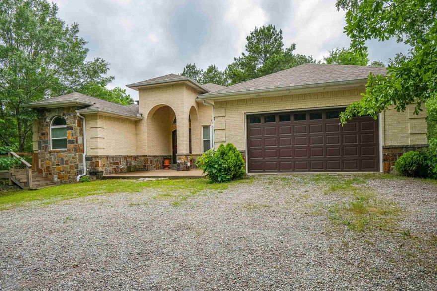 Discover this beautiful private home nestled on 6 wooded acres, just minutes from Lake Hamilton Schools. With 5 bedrooms, 4bathrooms, and multiple living spaces, this home offers room for everyone-plus the perfect layout for entertaining. The main level features a spacious kitchen with breakfast area and an open dining room, and a large main suite with private bath. Two additional bedrooms and bathrooms are also on the main floor, along with a versatile room that can serve as an office or extra bedroom. Downstairs you will find a generous entertaining space complete with bar, woodburning fireplace, plus another bedroom and full bath-ideal for guests or multigenerational living. Step outside to a peaceful deck surrounded by trees and nature, your own private retreat!
