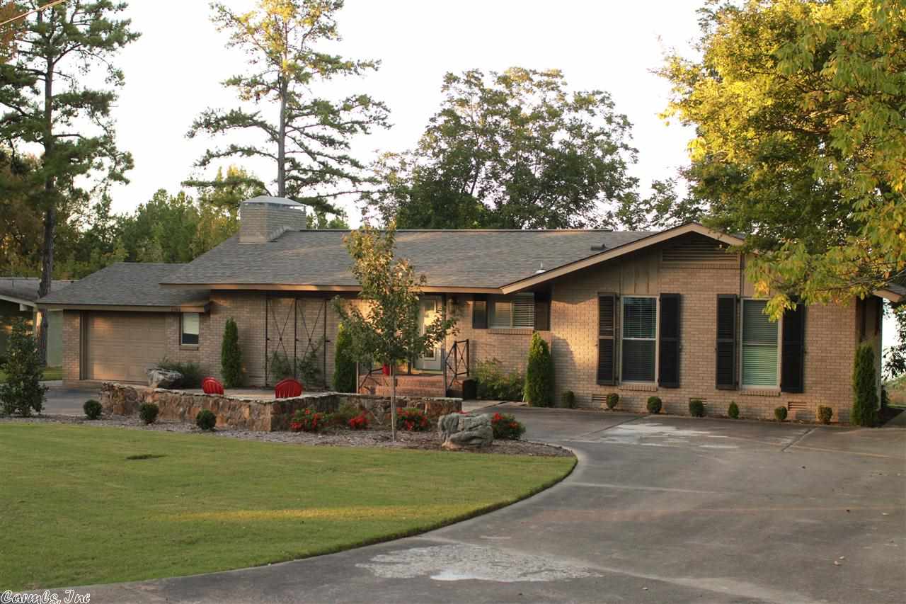 GREAT LAKE VIEW and the most convenient location in town! Easy walk to the lake, too. Home has been updated and up-scaled. Open floor concept and lots of storage, stone fireplace, vaulted wood ceilings in the entertainment area. Brick exterior, single garage on front and storage with garage door on back for those lake toys. Could easily be converted into a 3 bedroom home.