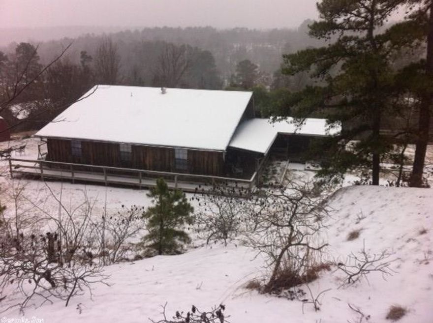 This unusual home has views from everywhere on almost 9 acres, including views of the river. The house has multiple decks and porches for outdoor enjoyment. It has a barn ready for horses and a fenced pasture area for them as well. It has a 2000 sq. ft. shop ready for your business, or to rent out. The shop is being sold furnished with air compressor and all furniture and equipment. The house is being sold furnished as well except for personal belongings. A great retreat.