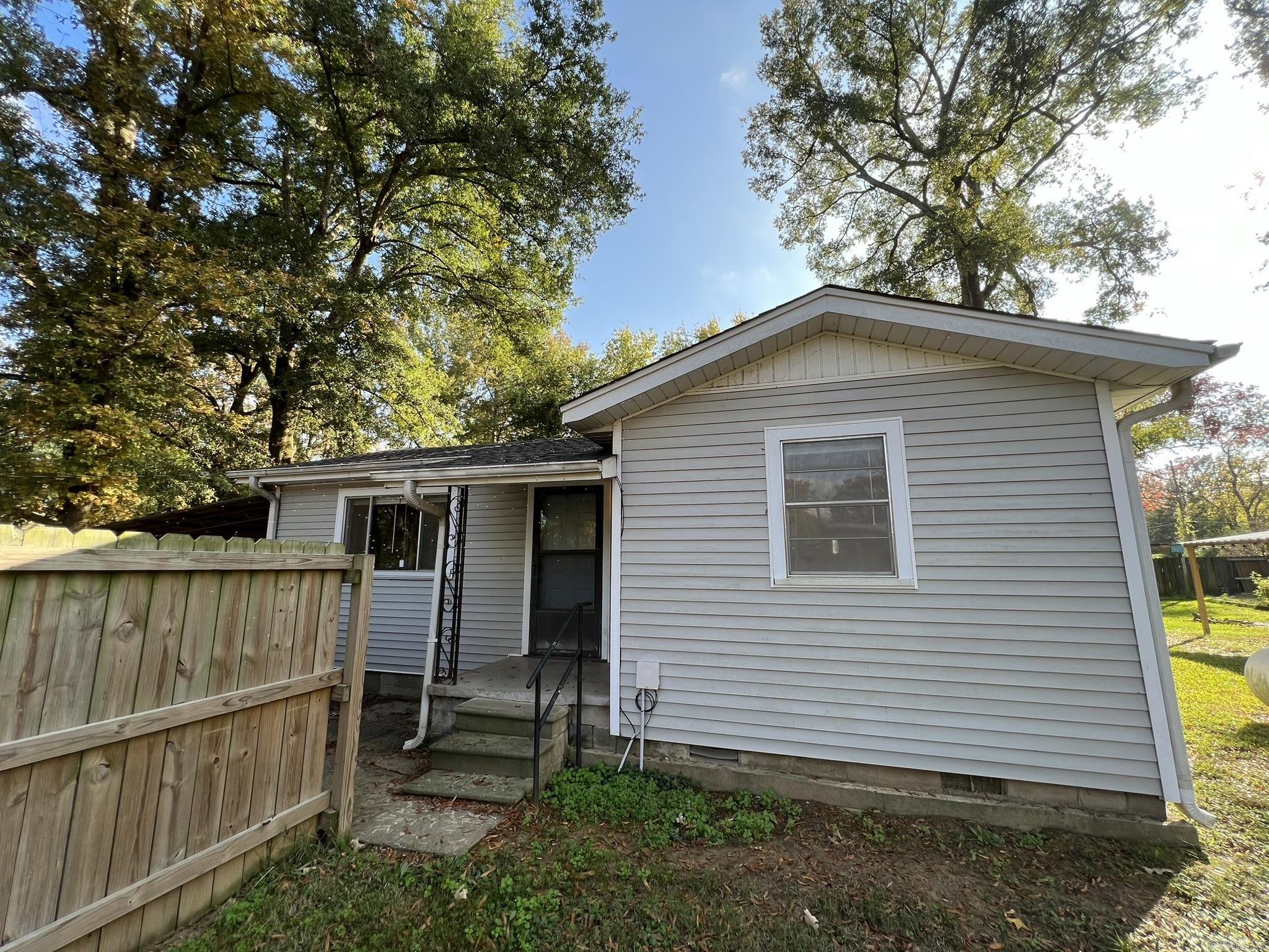 Experience the tranquil beauty of lakeside living and the charm of this two-bedroom, one-bathroom home just steps from Lake Conway. With the added bonus of a sunroom, laundry room, and a vast backyard spanning two lots, you'll have plenty of space to enjoy outdoor activities and hobbies. The fully fenced yard, complete with a 16x16 shop and a separate garden shed, provides endless possibilities. Updates such as new laminate flooring and a recently replaced roof add to the appeal of this property. Don't miss the opportunity to make this house your home. Schedule a viewing today and discover the magic of lakeside living for yourself!