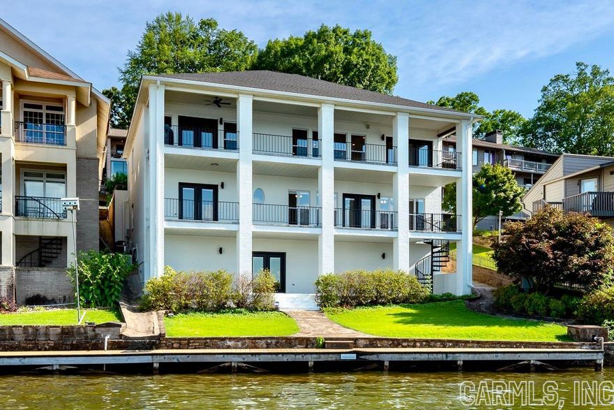 Come fall in love with this completely remodeled lakehouse, situated in the heart of the main channel of Lake Hamilton in Hot Springs. This 4 bedroom, 3.5 bath home features a main level owners suite, an oversized living room, quartz countertop kitchen with stainless steel appliances, and multiple dining areas. The second floor features a large living area, a kitchenette, three bedrooms, and two bathrooms. The walk-out basement would make an awesome game room and features an additional 636 SF of heated and cooled living space, bringing total living square footage to 4,325 SF. This home has so many opportunities for nightly rentals (Airbnb & VRBO) or for your primary living space. This home also includes a whole home generator, a covered boat slip, and a jet-ski slip. Call us today to schedule a tour, to see if this home is the one for you! Agents, please see remarks.