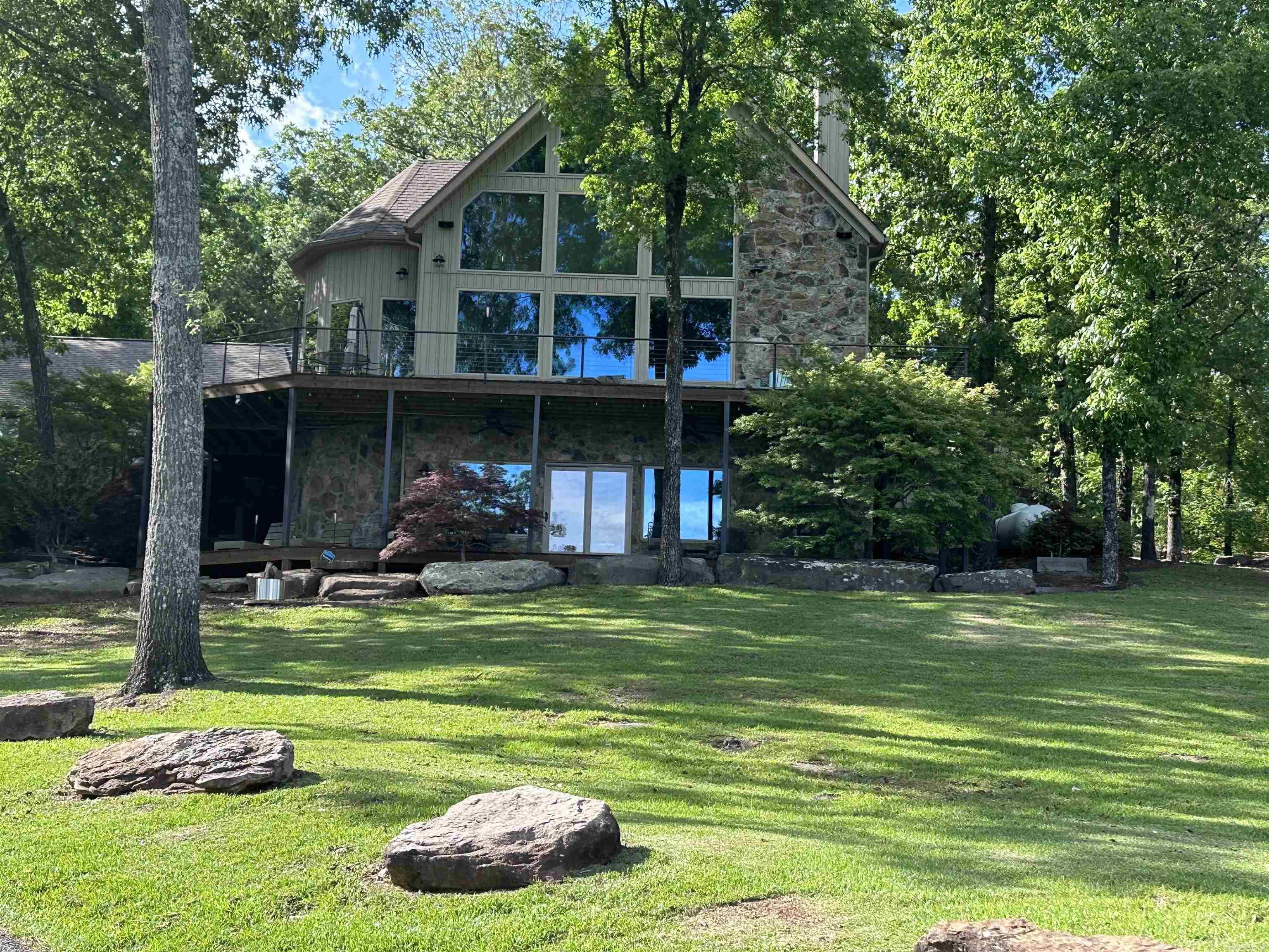 LAKEFRONT HOME ON GREERS FERRY LAKE with neighborhood launch & picnic area. Built by Willie Stone you will find every detail was well thought out. Features include vaulted ceiling, English Oak floors, floor to ceiling windows, heated floors, kitchen includes gas stove, granite counters, gorgeous cabinets, etc. Decks overlooking the lake, 2 car garage with living quarters, landscaping, sprinklers, generator, outdoor fountain & so much more. You will love everything about this home. Some furnishings convey.