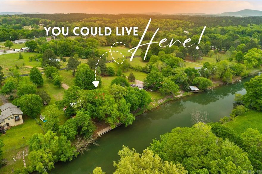 Tucked away in the natural beauty of Royal, Arkansas, this warm and inviting waterfront property at 361 Boulder Rd offers a peaceful retreat surrounded by nature. Nestled on a wooded lot of over an acre along the scenic Little Mazarn, the setting provides both privacy and a sense of calm, with gentle water views and mature trees creating a truly serene atmosphere.  The home features a cozy sunroom filled with natural light—an ideal spot to relax and enjoy the changing seasons or unwind at the end of the day. The property’s layout offers a welcoming feel, with open space across the front acreage and plenty of room to enjoy the outdoors.  Just steps from the water, a charming treehouse-style detached unit adds a unique and memorable touch. Perfect as a guest space, creative retreat, or quiet hideaway, it offers a special place to take in the peaceful surroundings.  With no restrictions on short-term rentals, this property also presents a wonderful opportunity for those looking to share its charm with others. Whether you’re seeking a full-time residence, weekend escape, or investment opportunity, this one-of-a-kind property captures the essence of nature-inspired living.