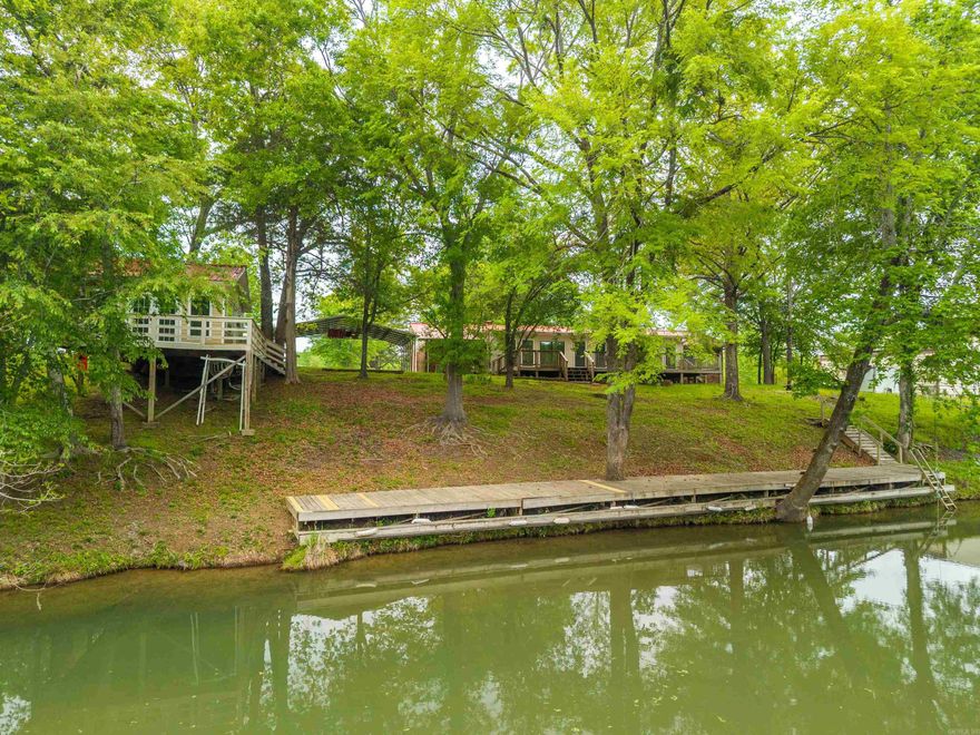 Tucked away in the natural beauty of Royal, Arkansas, this warm and inviting waterfront property at 361 Boulder Rd offers a peaceful retreat surrounded by nature. Nestled on a wooded lot of over an acre along the scenic Little Marzarn, the setting provides both privacy and a sense of calm, with gentle water and mature trees creating a truly serene atmosphere.   The home features a cozy sunroom filled with natural light, an ideal spot to relax and enjoy the changing seasons or unwind at the end of the day. The property layout offers a welcoming feel, with open space across the front acreage and plenty of room to enjoy the outdoors.   Just steps away from the water, a charming treehouse style detached unit adds a unique and memorable touch. Perfect as a guest space, creative retreat, or quiet hideaway, it offers a special place to take in the peaceful surroundings.   With no restrictions on short term rentals, this property also presents a wonder opportunity for those looking to share its charm with others. Whether you are seeking a full time residence, weekend escape, or investment opportunity, this one of a kind property captures the essence of nature inspired living.