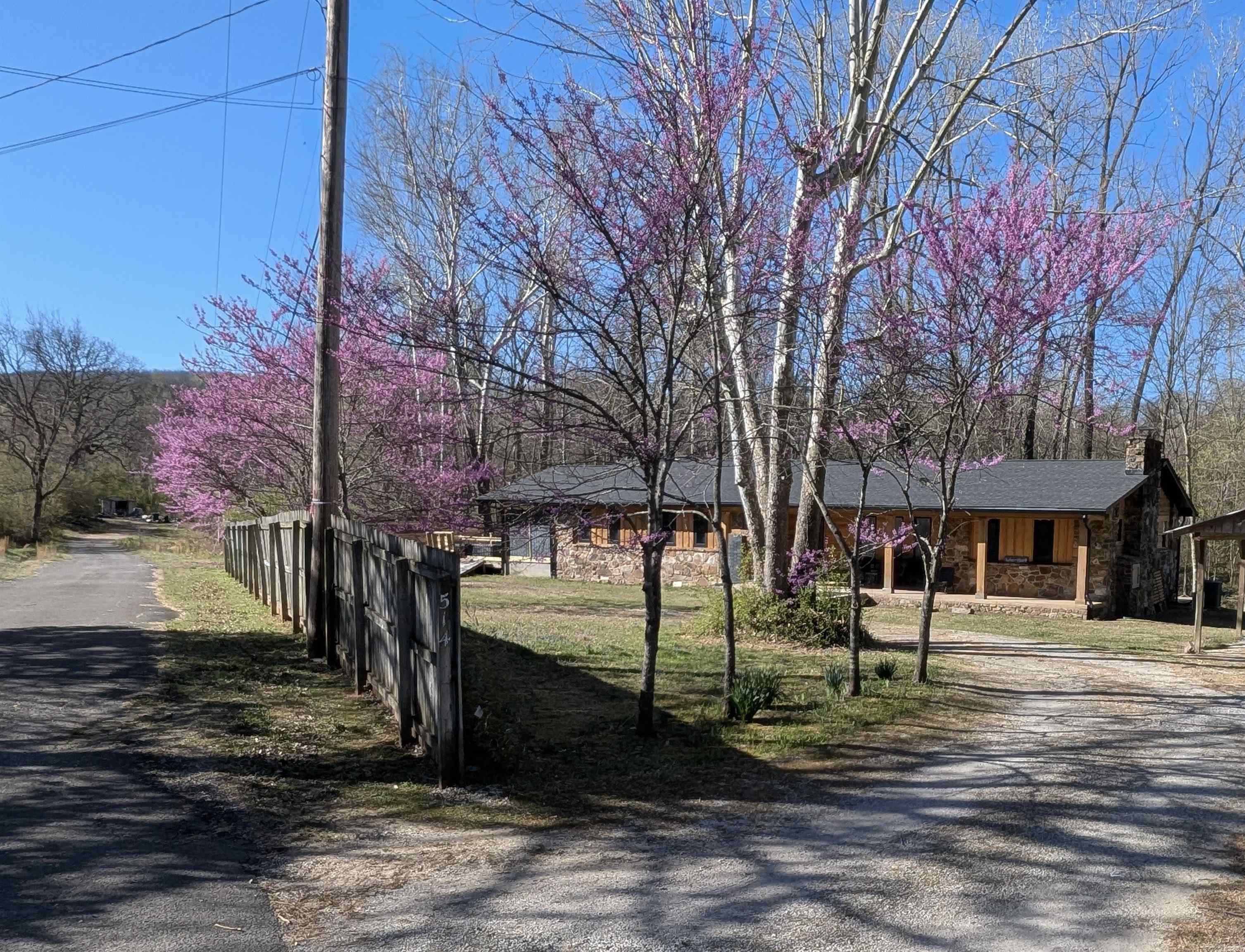 Price Reduced inline w/ Apr Appraisal. Only resident on dead-end street and 2 blocks from historic court house, home is ultra private woodland creek enclave - with many locals unaware of its existence. Spa-like features not available elsewhere. Contact office - 8 video links. Full gut remodel and small primary suite addition completed 2024 - NEW improvements: roof (3/25), HVAC, cypress siding, gutters, all flooring (some heated), walls, wiring, high end windows, solar tube lights for daylight and ambient night lights, on demand instant hot water, reclaimed kitchen island, 3 ice maker types, wet bar, Italian cooktop, high capacity W&Ds, custom copper insulated bathtub made in India, heated swimming pool spa custom designed care-free, 2-3 person hot tub with neck / shoulder jets and finally picture windows and decking galore to re-situate the views towards the lively year round creek, field and woods. Selling turn key - all conveys with exception of handful items. Fab short term vacation rental in a proven emerging market or better yet, your next home. House NOT in FEMA flood zone. Separate driveway on Webb St begs for an ADU or subdivide