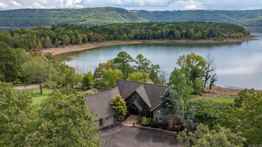 Escape to this stunning LAKEFRONT retreat on GREERS FERRY LAKE in Arkansas with 2 large lots and a boat launch just behind the home. With space to sleep your family and friends and store your lake toys, this home is perfect for seeking serenity and adventure. This expansive home has access to the patios and a view from every bedroom and both living spaces with 2 levels of windows framing the panoramic views or the water. Imagine waking up to the glistening water, spending you days boating, fishing, or simply relaxing by the shore.  This rare find is ideal for family getaways, a corporate retreat, or your dream full-time residence.