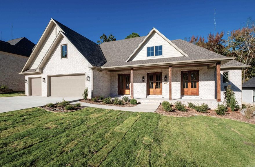 Newly constructed feature rich home backs up to the Bear Den Wild Life Preserve. The 4268 SF 4 bed/4.5 bath home is located on a level lot with 3 bedrooms on the main level. Office is directly off the main entry with 2 sets of French doors. The large primary suite offers spa-like bathroom, make-up vanity, full length mirror, soaker tub, walk-in shower, & linen closet. The adjoining closet has laundry room access providing extensive storage and wall mounted ironing board. The kitchen offers abundant cabinets, a large island with quartzite top, 6-burner gas stovetop, double oven, microwave, & walk-in pantry.  The adjacent dining room has a built-in buffet with Tudor style glass doors & matching quartzite top. The gas log fireplace in the living room is trimmed in fluted tile and surrounded by built-ins. Upstairs find a bedroom, bath, craft room, lounge and large flex space. Outdoors provides an ideal place to entertain and enjoy nature on the private covered porch with fireplace. Three car garage, copious storage, high efficiency systems, hardwood floors through most of the home complete this traditionally styled residence. Enjoy miles of private walking/bike trails in Bear Den.