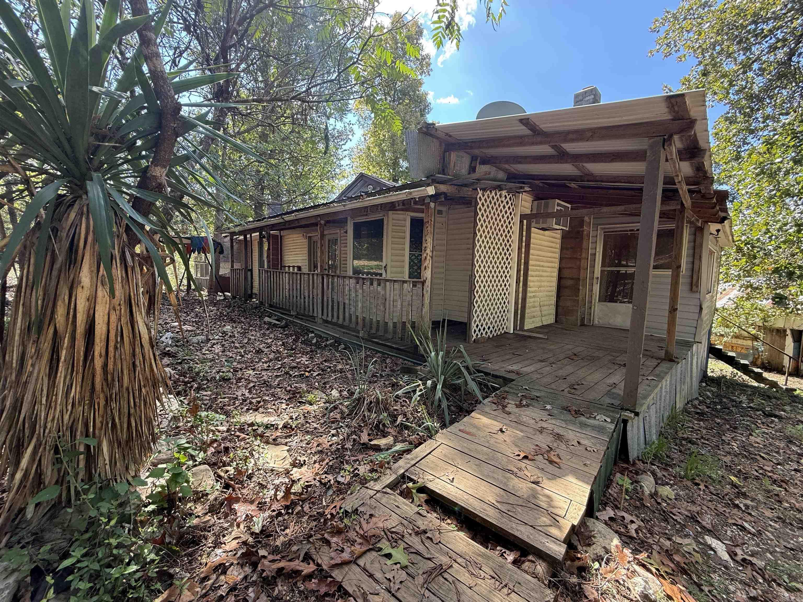 5.4 Acres m/l with Home, Workshop, and Outbuildings ā Needs Work but Full of Potential Situated on 5.4 acres m/l, this property includes a roomy 3 bedroom, 2 bath home with decking along nearly all sides. Portions of the decks show wear and will need attention. Inside, the home offers plenty of space and potential, though updates and repair work are needed throughout. An outdoor kitchen area is located on the back deck. The property includes several outbuildings: two storage sheds, a machine shed, a well house, an older camper, and another structure that could serve as a barn once a new roof and finishing work are completed. A large workshop with water and electric is also on site, though it will benefit from repairs. The acreage supports abundant wildlife, including deer, turkey, and squirrels, and is just about 5 miles from the Spring River, known for its world-renowned trout fishing. With multiple improvements already in place, this property presents a project with a variety of features to work with.