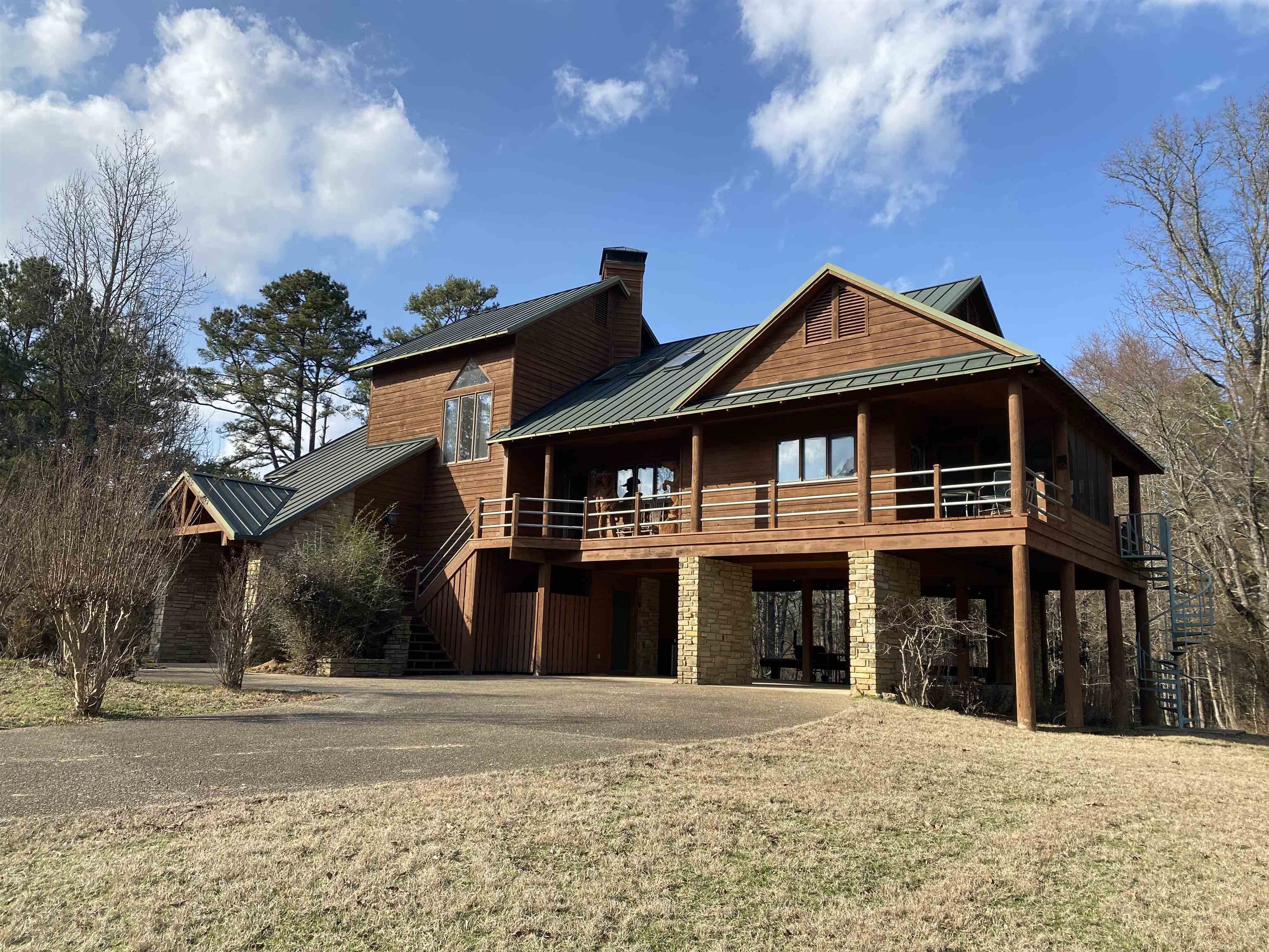 Beautiful Lake Ouachita home located minutes from the boat launching ramp and swimming area at Twin Creek Recreation area. You will feel the stress melt away the minute you drive through the gate and start up the concrete drive to this 3 level home. 4 bedrooms and 3 1/2 baths, (2966 sq ft) provide all the space and privacy you need for your family and friends. 2 bedrooms, 1 bath located on the first floor, primary bedroom and bath located on the main floor, and the 4th bedroom and bath are located on the 3rd floor. Main floor of the home has the open concept so everyone is included in the fun with a vaulted wood ceiling, large rock fireplace and lots of windows to bring in that natural light. Kitchen has bar seating for 6 with plenty of cabinets for storage and a pantry. Screened deck is located just off the kitchen for that morning coffee and a open deck wraps around to the rear and front of the home. A spiral staircase off the deck takes you down to the grassy area with lots of room for the kids to run and play. Home sits on 4.03 acres at the top of the hill and backs up to the Corp of Engineers property. This home is a rare find and won't last long! Call today!