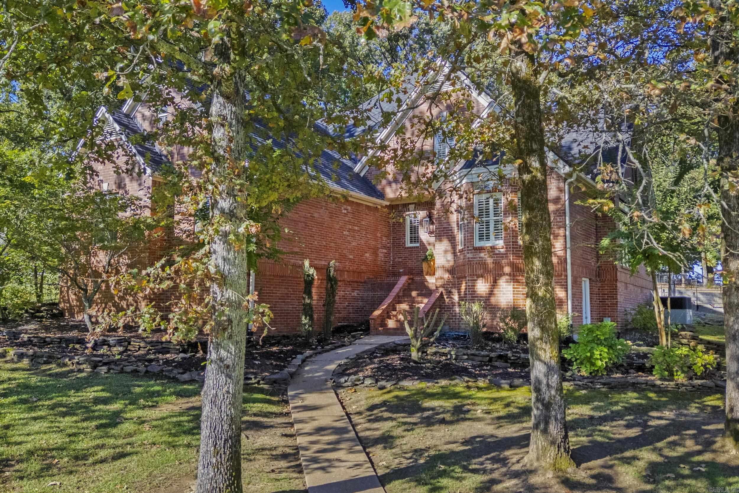 Beautifully maintained, one owner home shows pride of ownership inside and out. Peaceful corner lot w/trees, extensive landscaping & sprinkler system. Spacious primary suite is located on the main level along w/half bath, gourmet kitchen w/breakfast area & formal dining space. A cozy living room w/gas fireplace plus a second room for a den area complete the main level. The upstairs features a generous amount of space with two bdrms featuring a jack n jill style bath & an extra room for a playroom or home office. Hardwood flooring in living room, dining room & den area. Travertine stone is be found in the kitchen, primary bath & upstairs bath. Kitchen is a cooks dream w/granite countertops, breakfast bar, wall oven & microwave, deep drawers & gas cookstove. Handy built in desk completes the kitchen. Gorgeous wooden window shutters. Floored attic space plus walk in storage area underneath home. Walk in closets, linen storage closets, & a window seat (in spare bdrm) provide ample amounts of extra storage. Upgraded light fixtures & kitchen cabinetry, custom staircase & custom gas fireplace mantle and fireplace surround. Short golf cart ride to the River Oaks golf course.