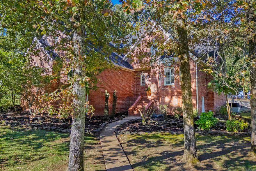 Beautifully maintained, one owner home shows pride of ownership inside and out.  Peaceful corner lot w/trees, extensive landscaping & sprinkler system.  Spacious primary suite is located on the main level along w/half bath, gourmet kitchen w/breakfast area & formal dining space.  A cozy living room w/gas fireplace plus a second room for a den area complete the main level.  The upstairs features a generous amount of space with two bdrms featuring a jack n jill style bath & an extra room for a playroom or home office. Hardwood flooring in living room, dining room & den area. Travertine stone is be found in the kitchen, primary bath & upstairs bath.  Kitchen is a cooks dream w/granite countertops, breakfast bar, wall oven & microwave, deep drawers & gas cookstove.  Handy built in desk completes the kitchen.  Gorgeous wooden window shutters.  Floored attic space plus walk in storage area underneath home. Walk in closets, linen storage closets, & a window seat (in spare bdrm) provide ample amounts of extra storage.  Upgraded light fixtures & kitchen cabinetry, custom staircase & custom gas fireplace mantle and fireplace surround.  Short golf cart ride to the River Oaks golf course.