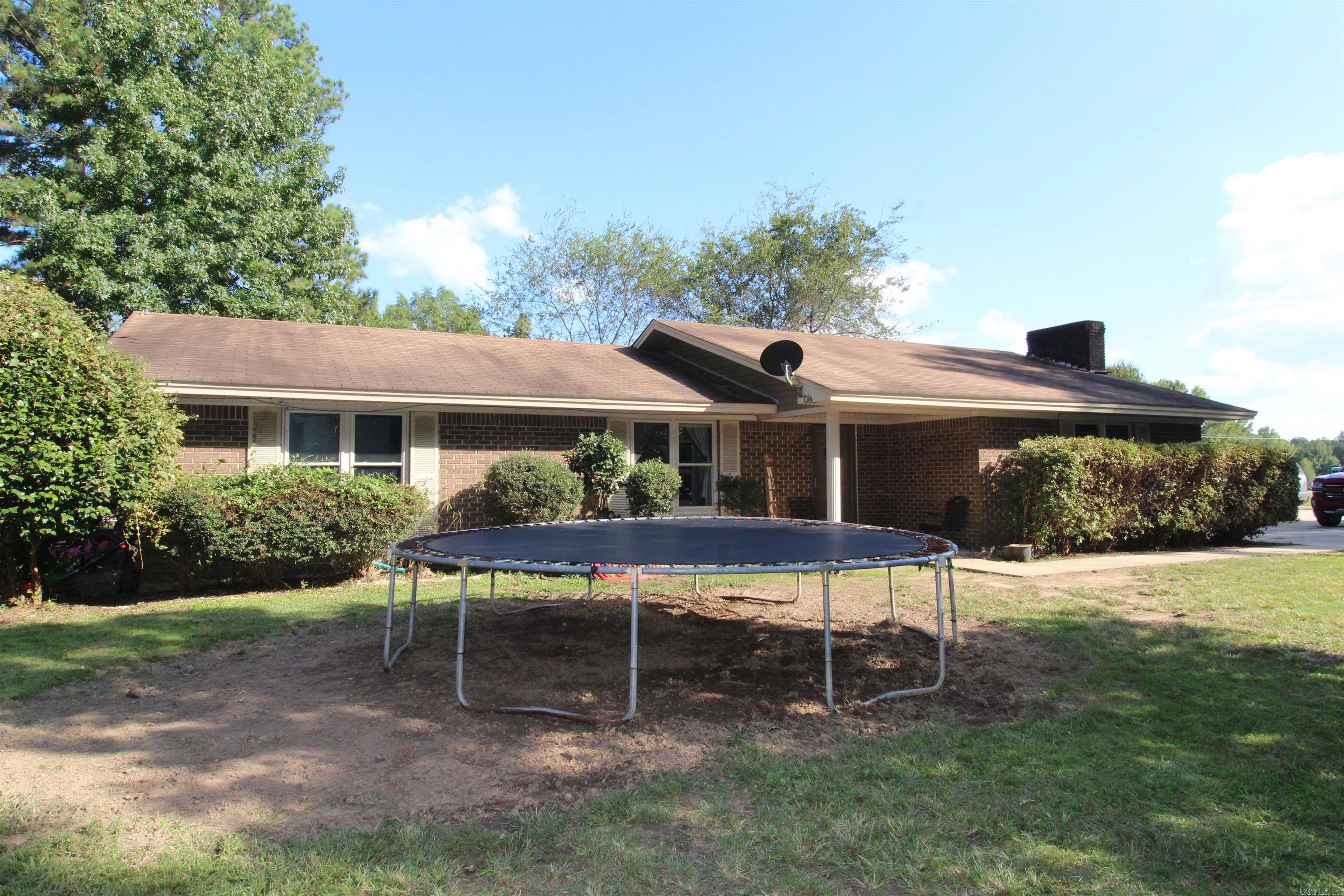 Here's a good buy! Less than $76.00 a square foot! 1865 square feet. Wood burning fireplace. 4 bedrooms and 1.5 baths. Fenced yard and storage building. Enclosed sunporch and covered patio. Concrete floors. Rustic!